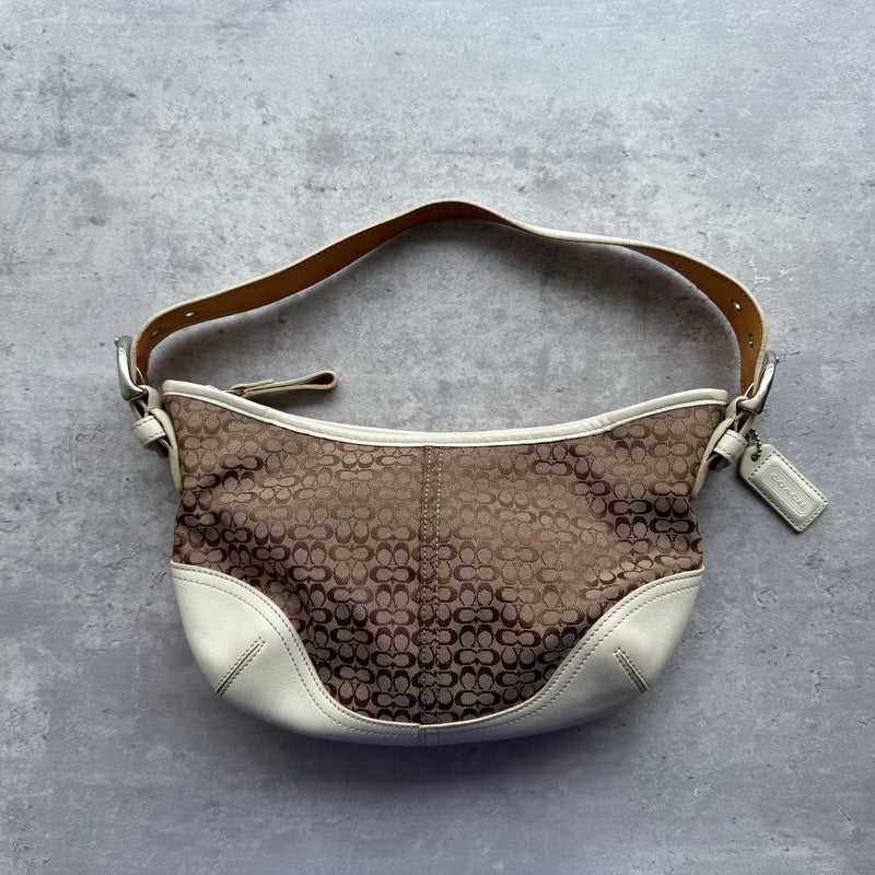 Coach Signature Mini Sufflette Shoulder Bag in beige jacquard with white leather trim, adjustable strap, and beige fabric lining.