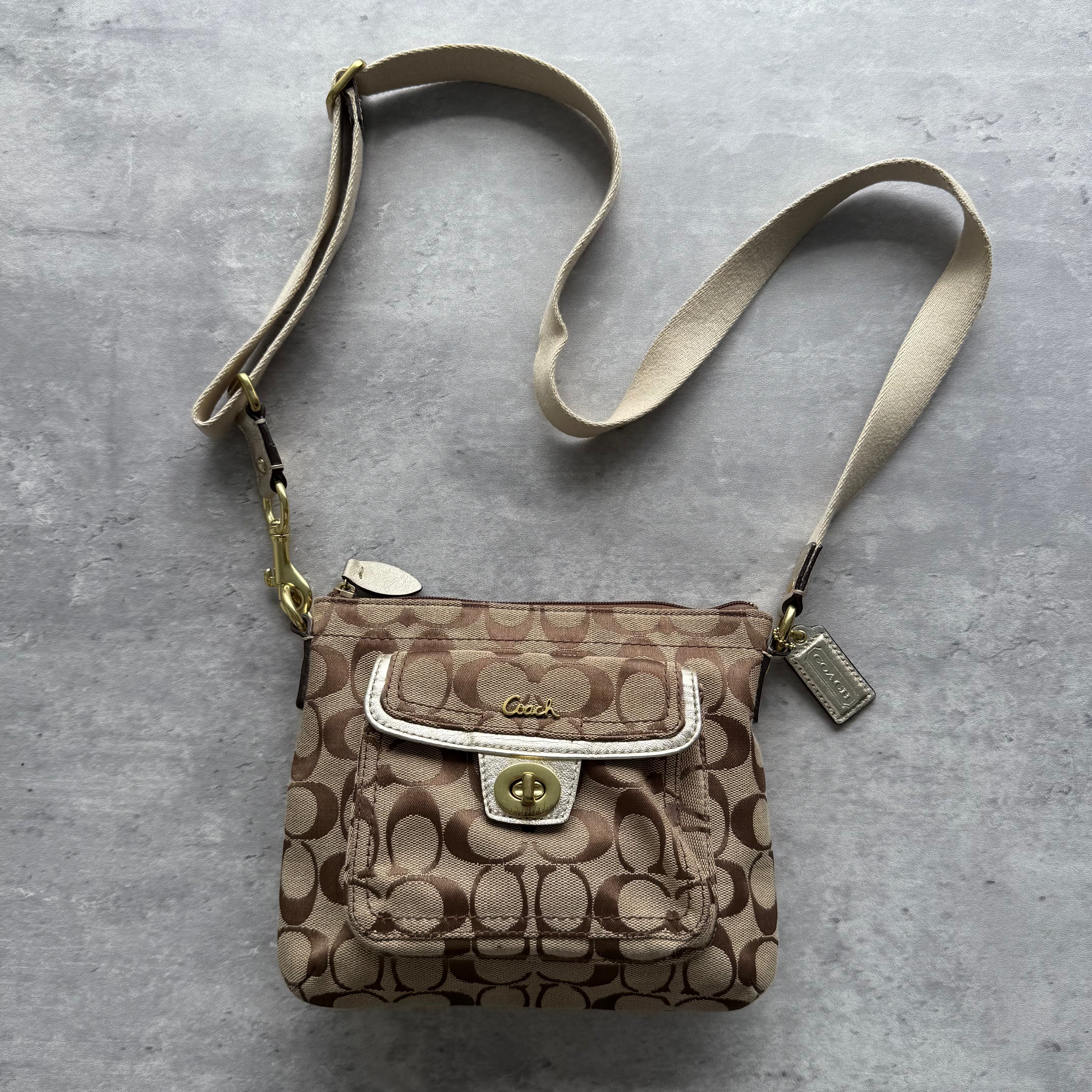 Coach Signature Penelope Turnlock Messenger Crossbody Bag in beige jacquard canvas with leather trim and gold-tone hardware.