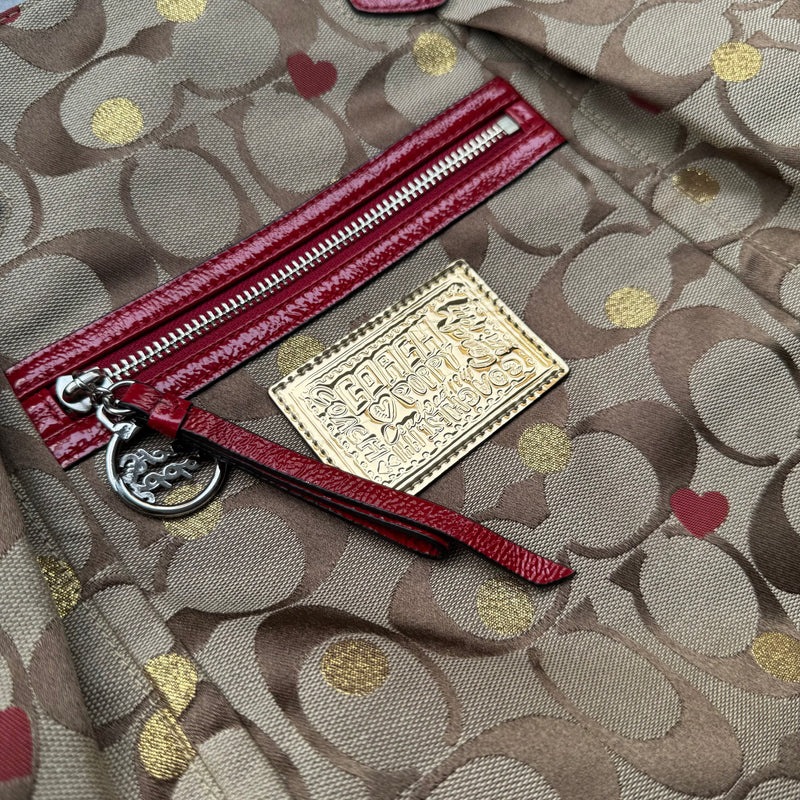 Coach Signature Poppy Laura Secret Admirer Tote Bag in brown monogram canvas with red and gold heart dot accents and red patent leather trim.