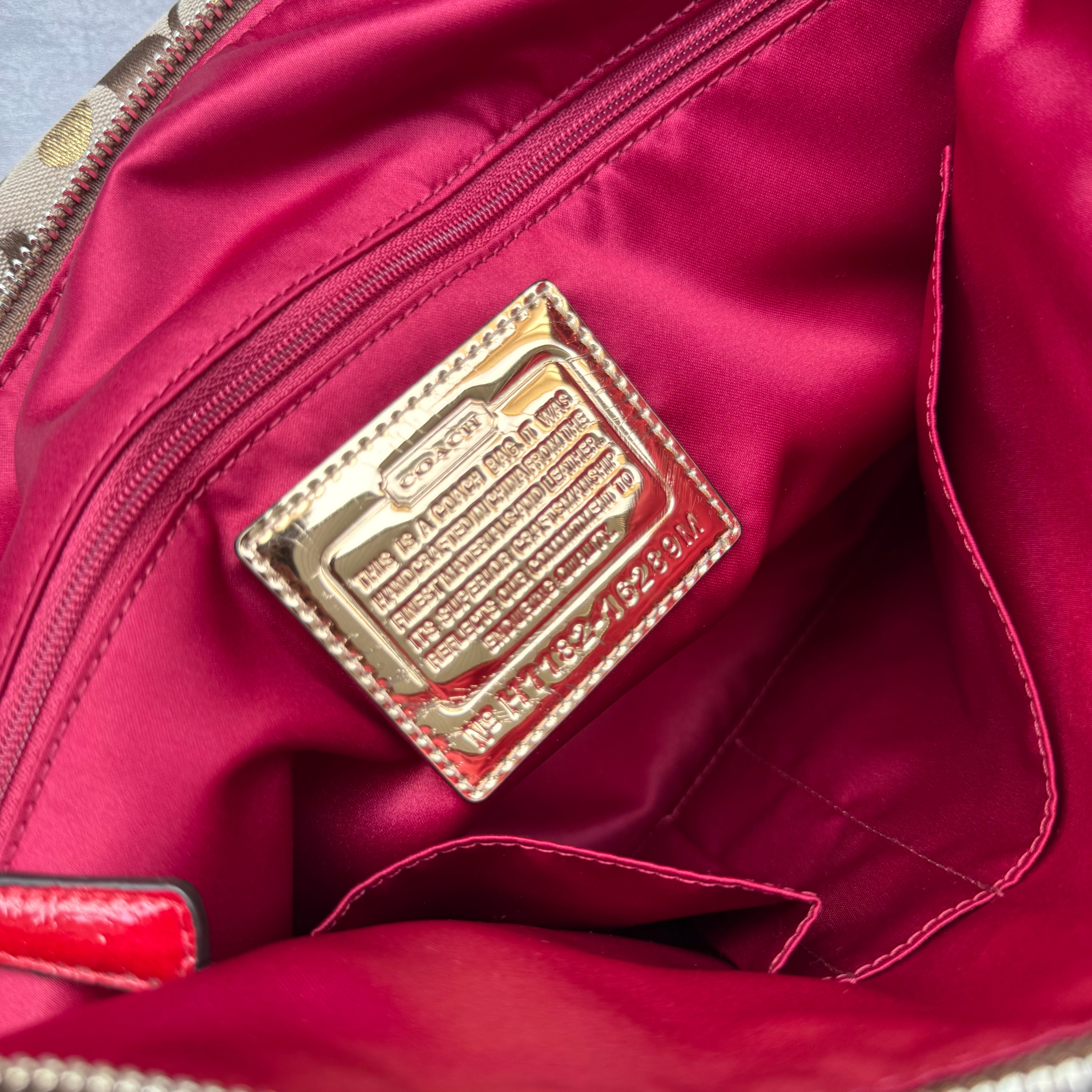 Coach Signature Poppy Laura Secret Admirer Tote Bag in brown monogram canvas with red and gold heart dot accents and red patent leather trim.