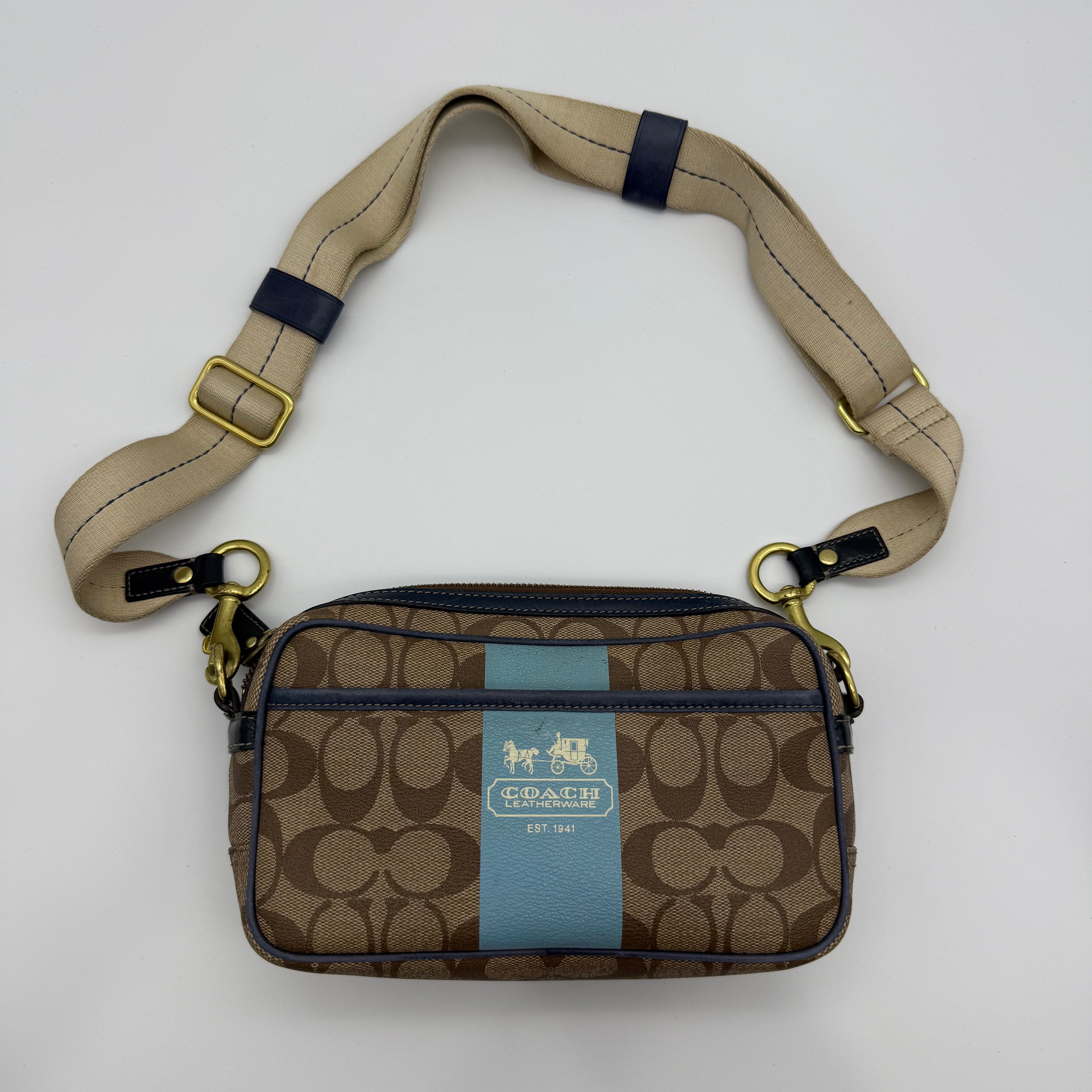 Coach Signature Stripe Jaime crossbody in beige jacquard with blue center stripe, navy trim, and webbing strap — pre-loved.