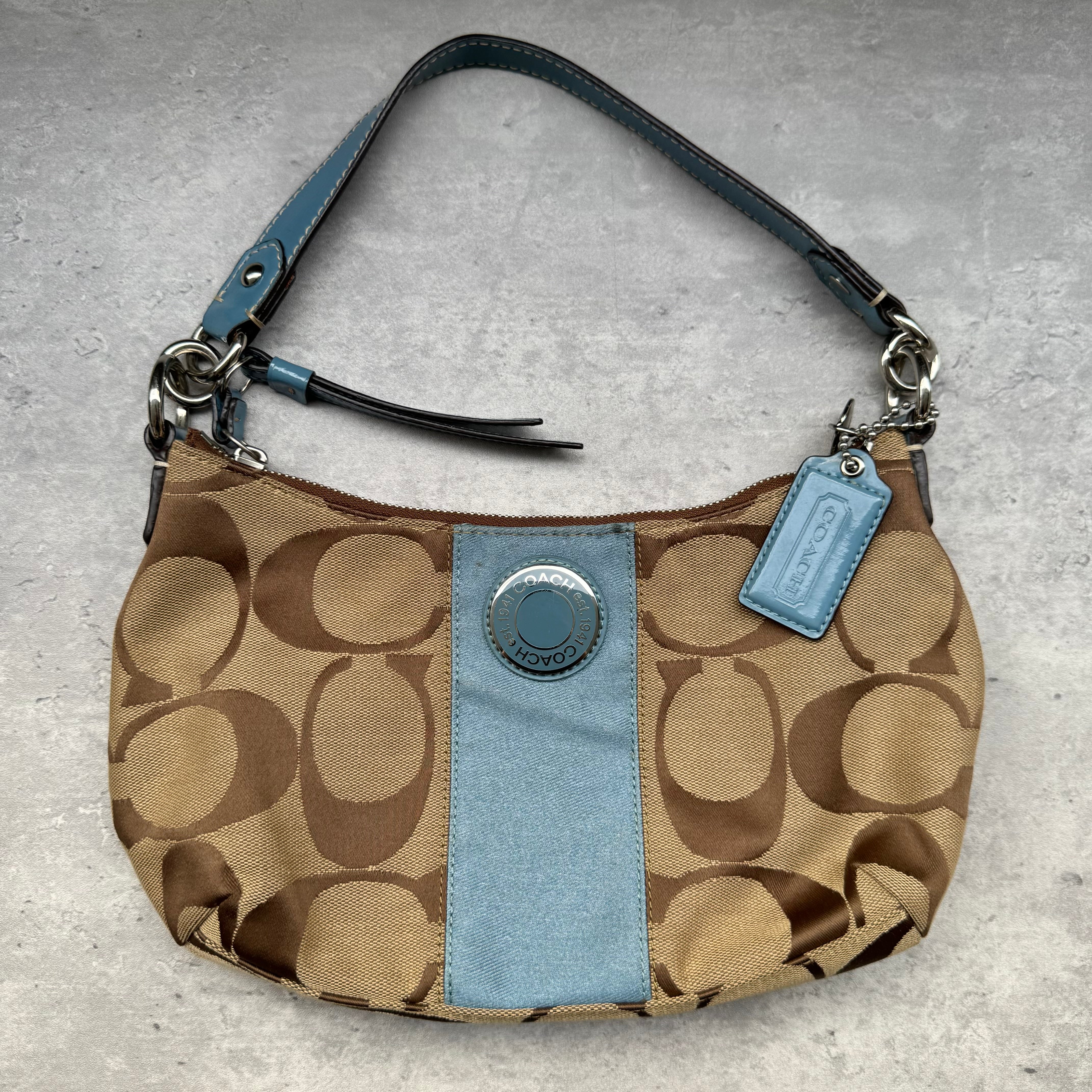 Coach Signature Stripe Shoulder Bag in brown canvas with blue leather trim and vertical logo stripe.