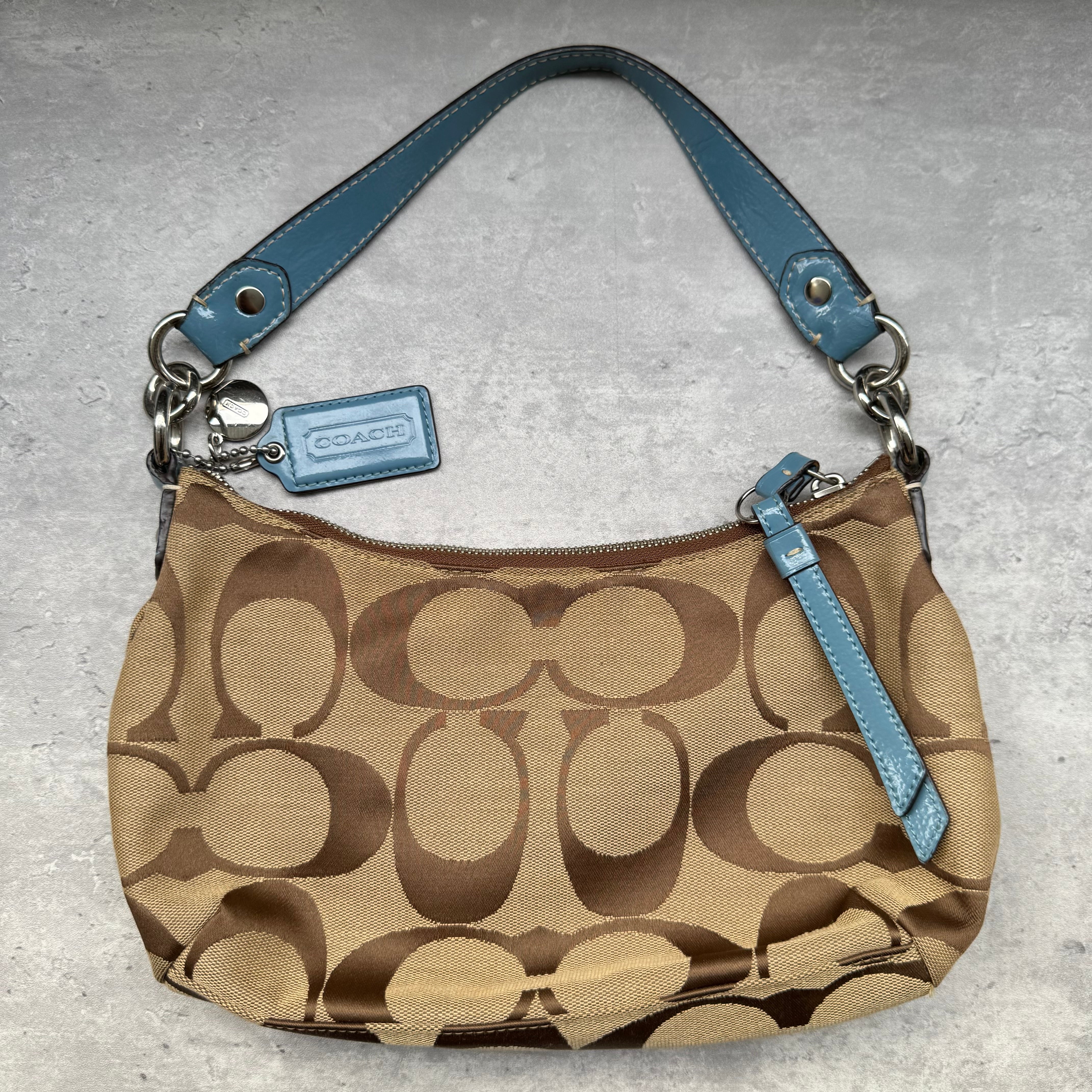 Coach Signature Stripe Shoulder Bag in brown canvas with blue leather trim and vertical logo stripe.