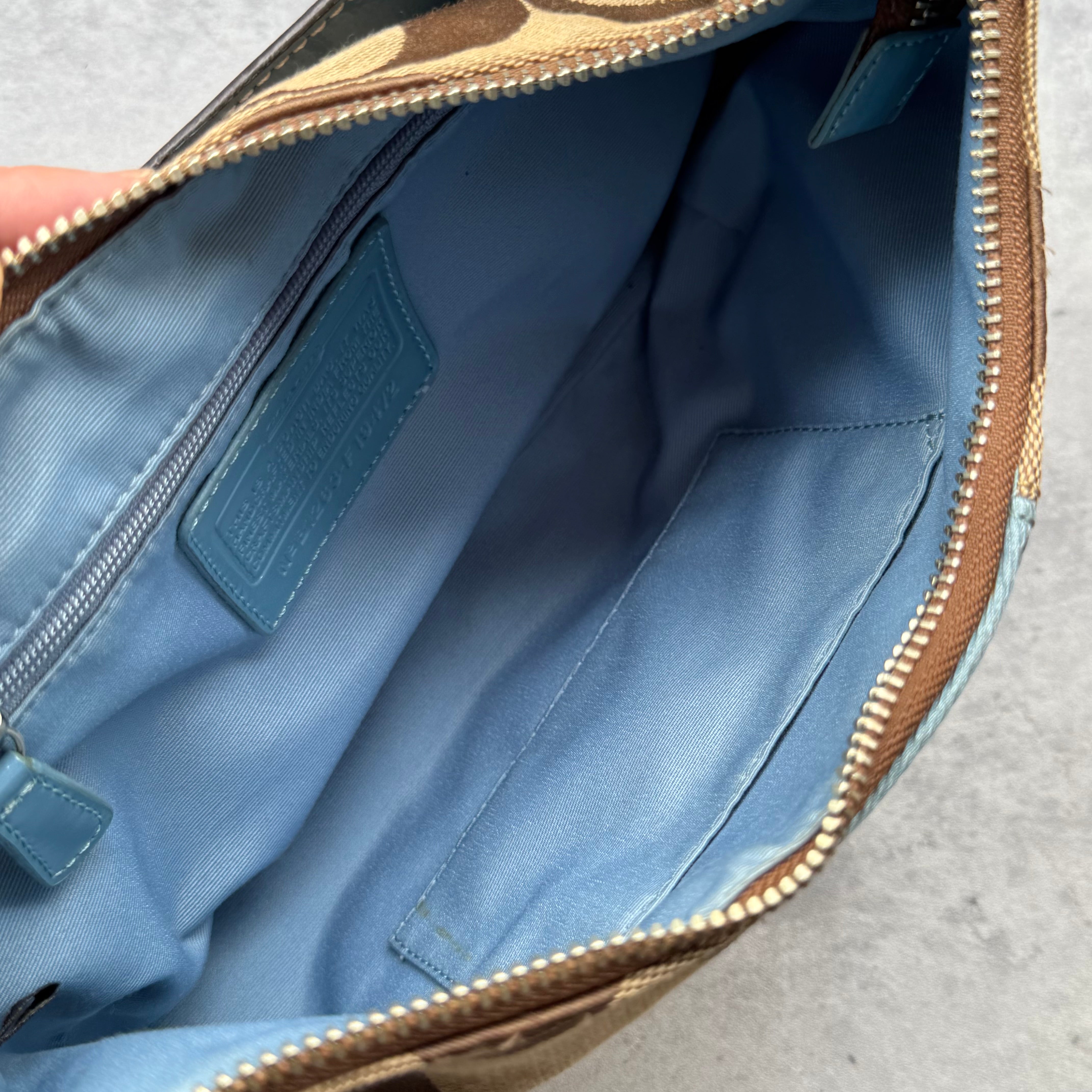 Coach Signature Stripe Shoulder Bag in brown canvas with blue leather trim and vertical logo stripe.