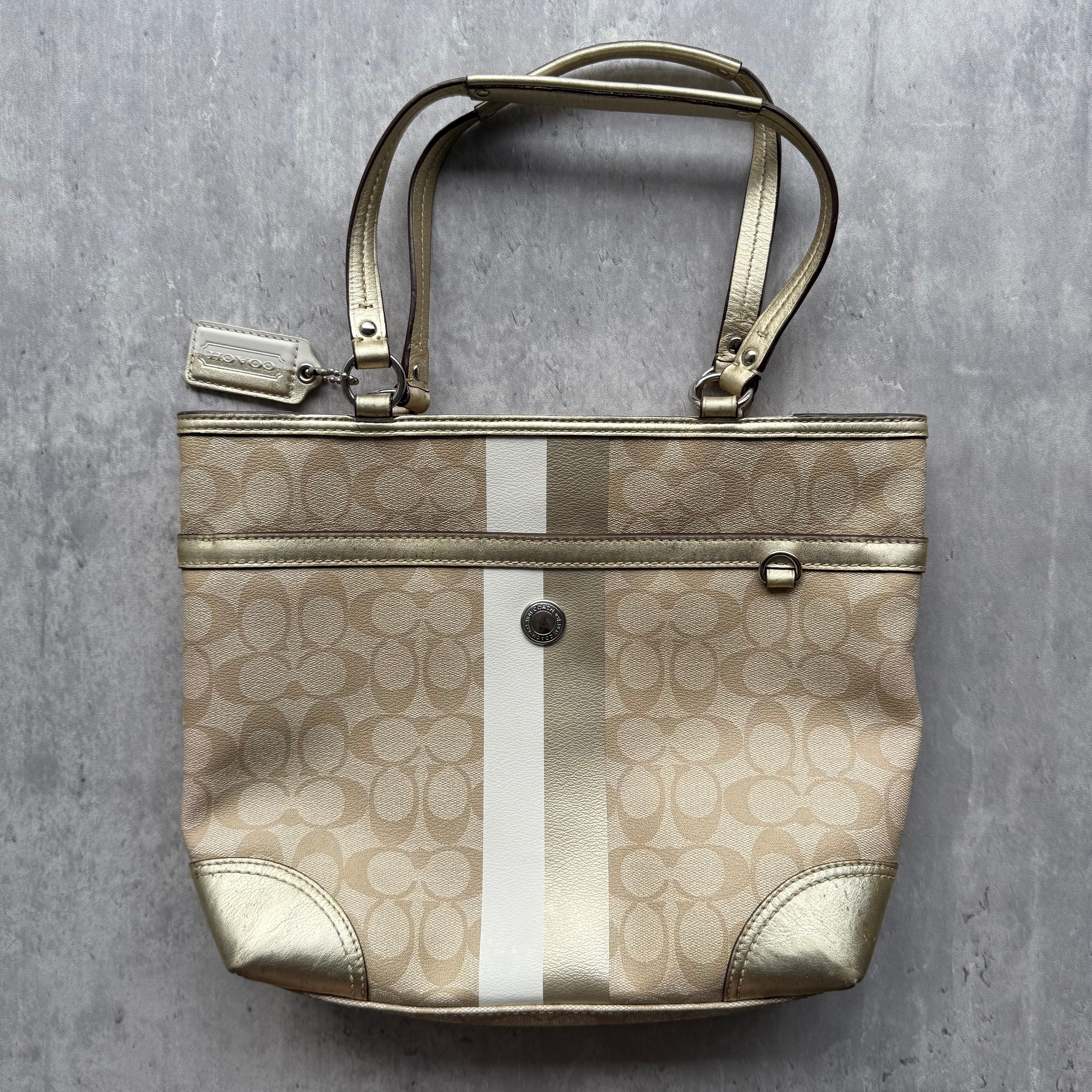 Coach Signature Stripe Tote Bag in beige monogram canvas with gold leather trim, white stripe detail, and red interior lining