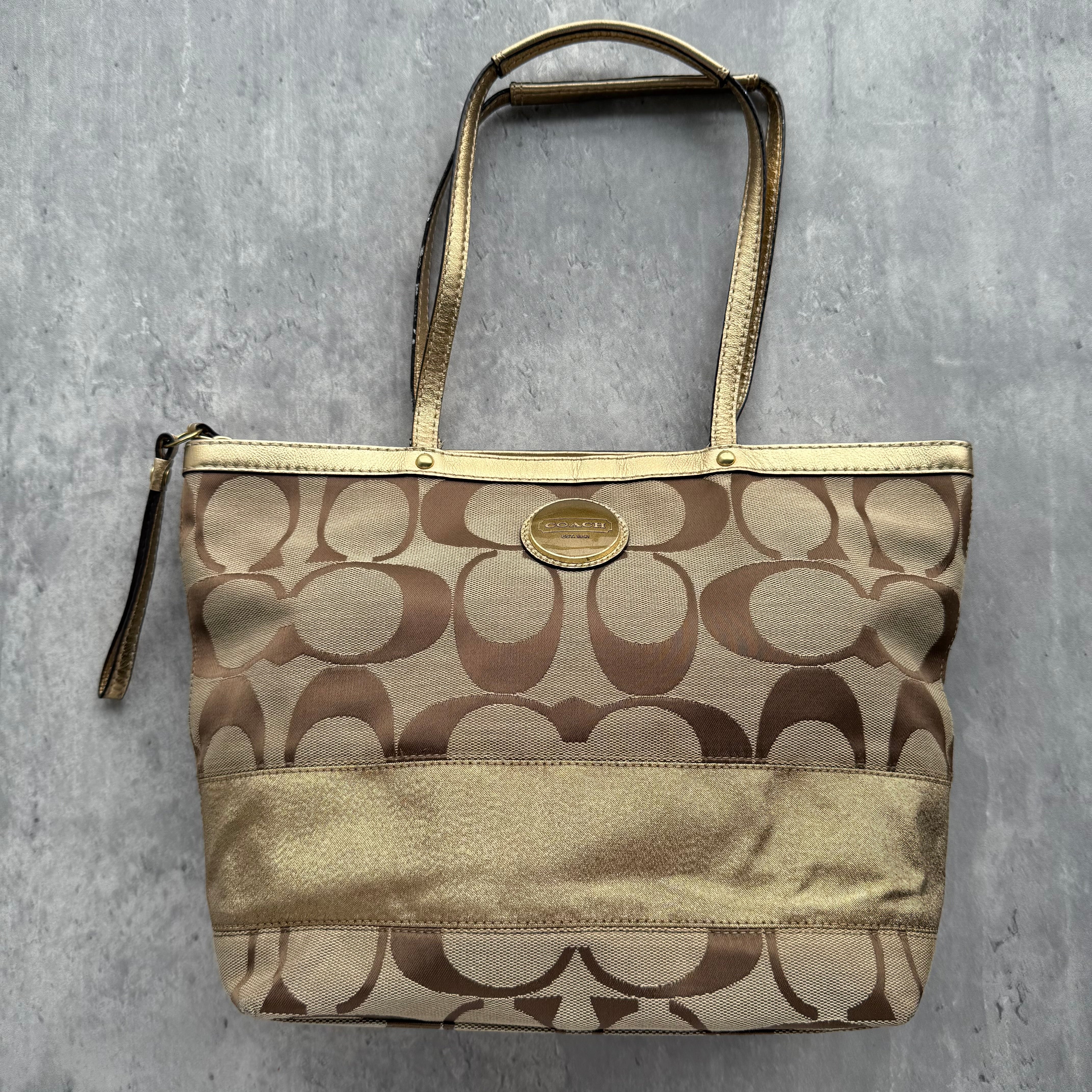 Coach Signature Stripe Tote Bag Gold/Beige in jacquard canvas with metallic leather trim, featuring spacious interior with lilac lining and top zip closure.