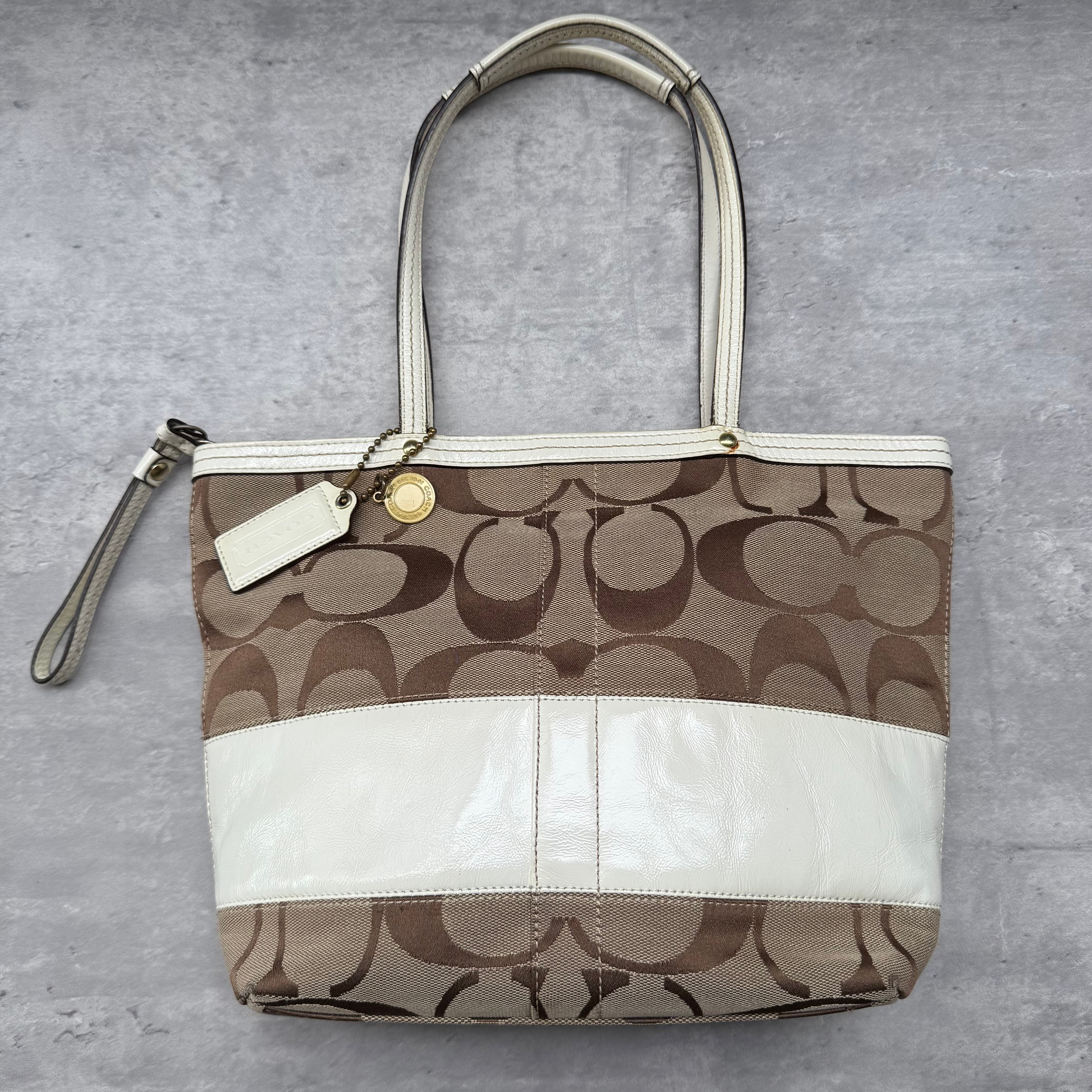Coach Signature Sufflette Tote Bag Beige/White, featuring coated canvas with leather trim and pink interior lining.