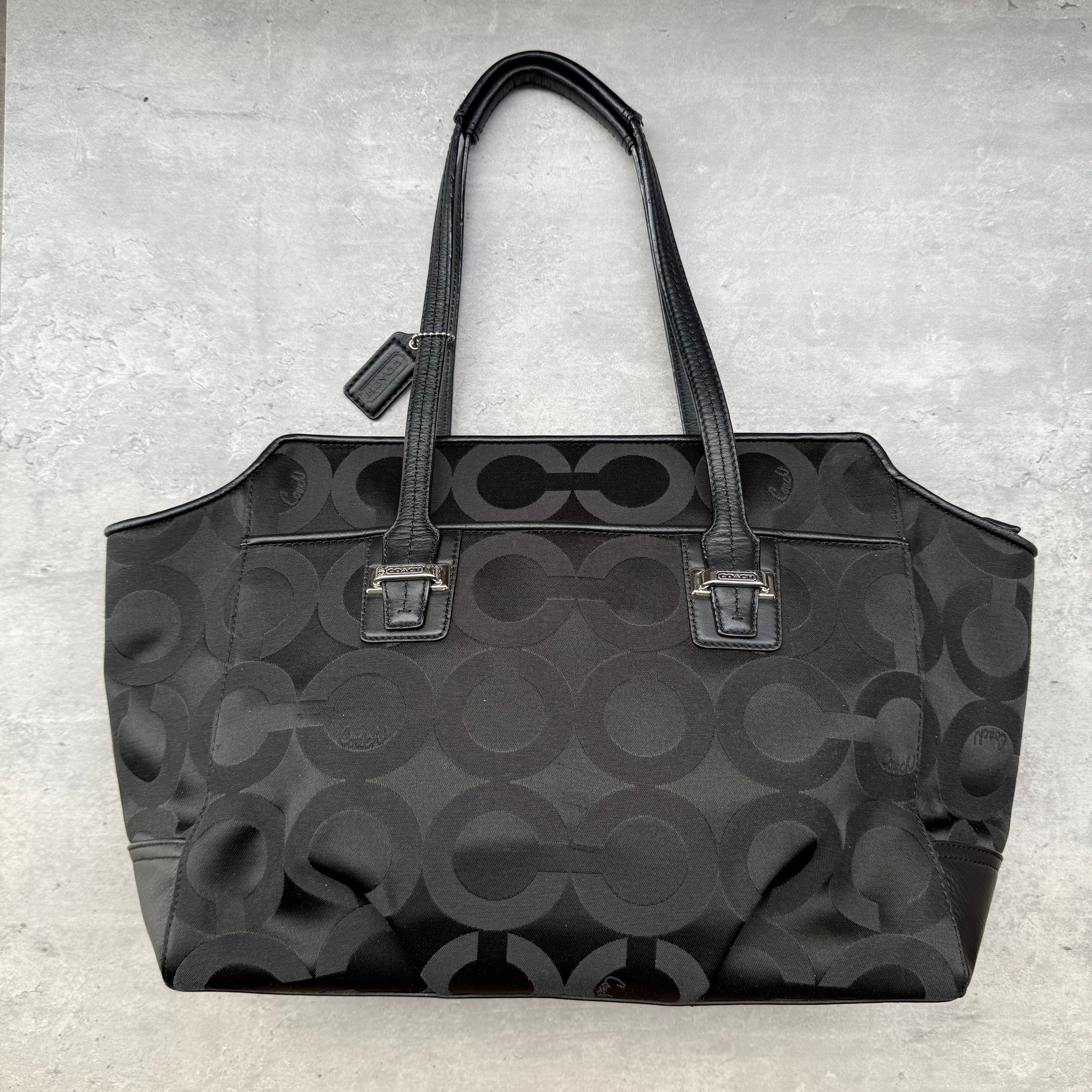 Coach Taylor OP Art Alexis Carryall Handbag in black jacquard with leather trim and silver-tone hardware, featuring spacious interior and dual shoulder straps.