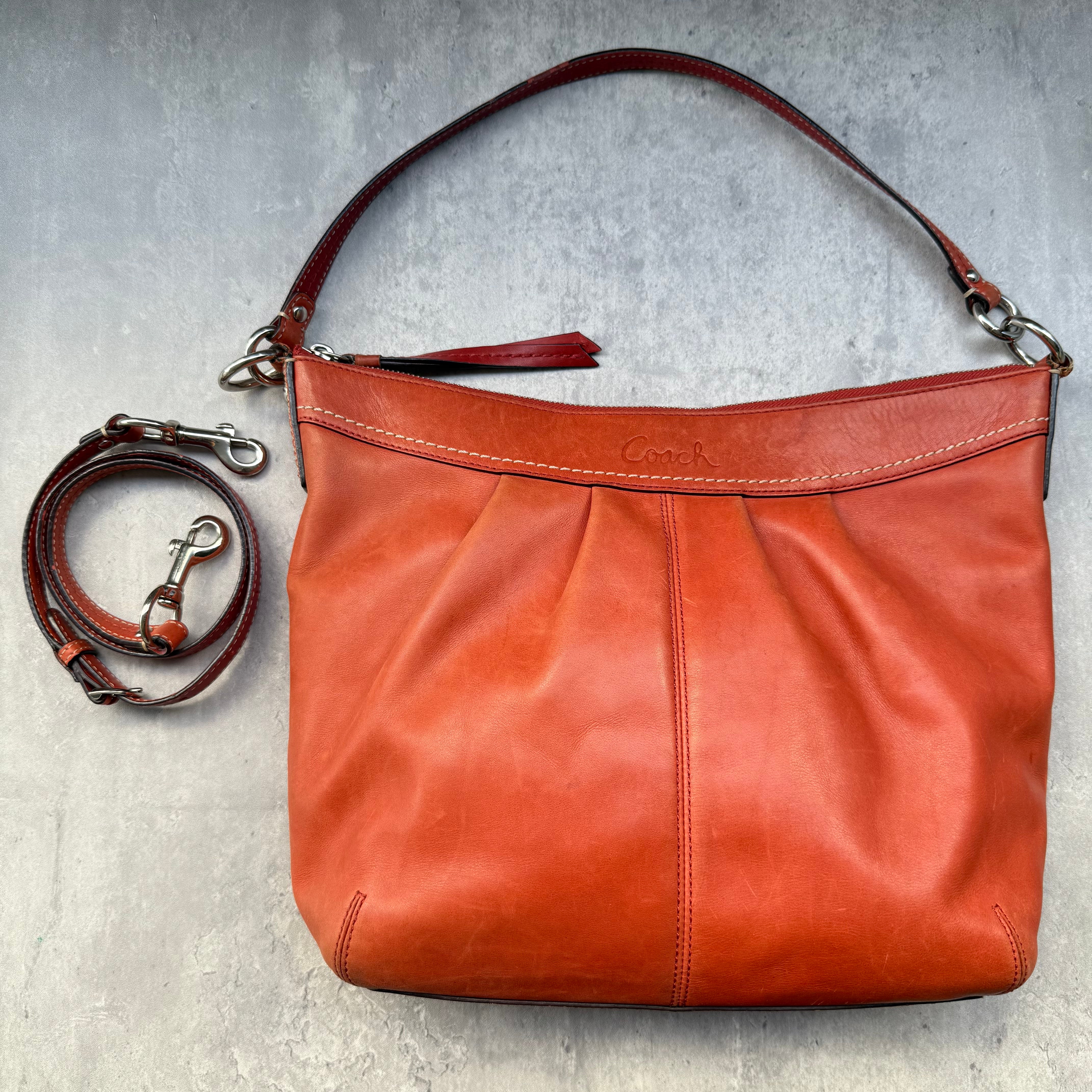 Coach Y2K Ashley Hobo 2Way Shoulder Bag in burnt orange leather with pleated design and detachable crossbody strap.