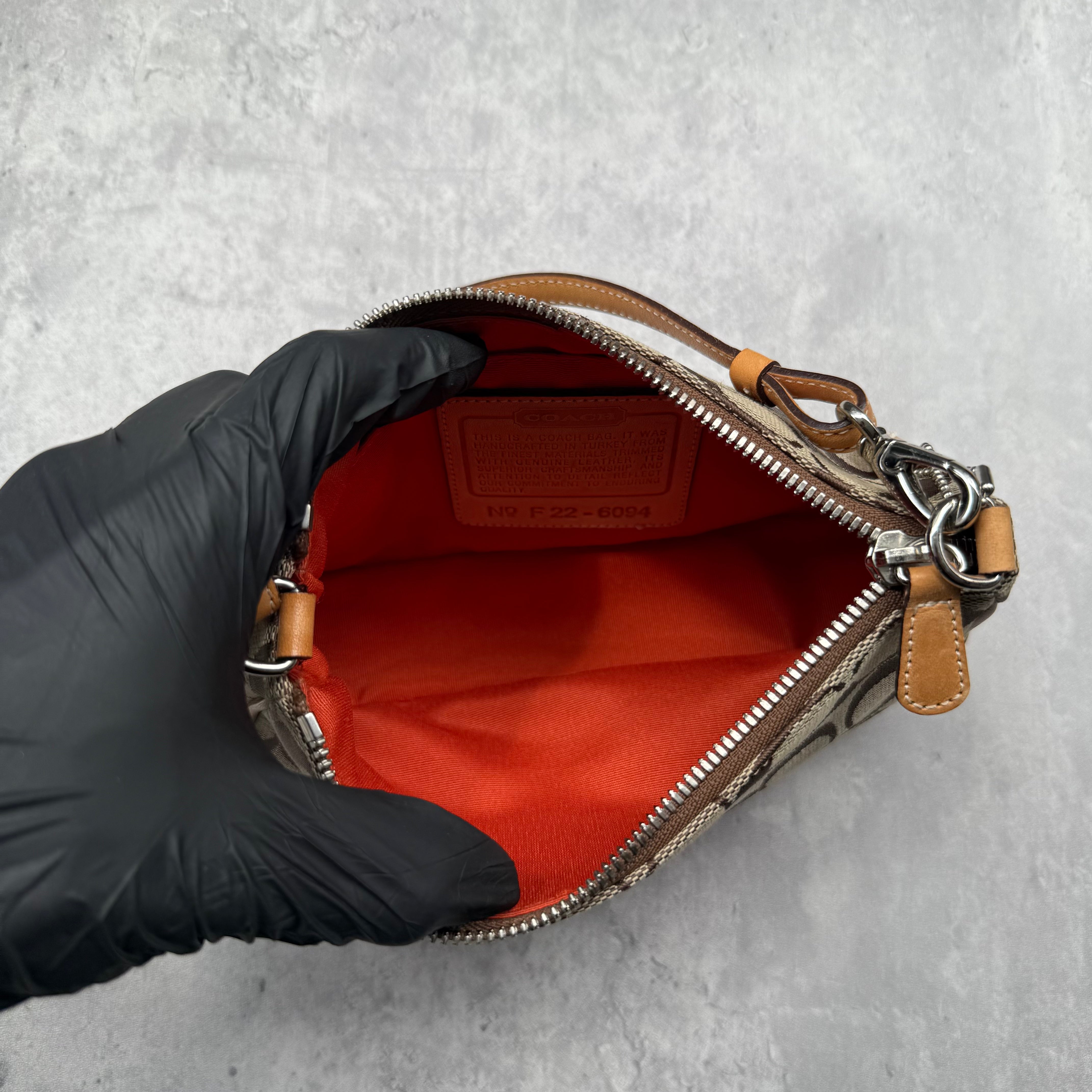 Coach Y2K Demi Shoulder Bag Tan, featuring signature monogram canvas, tan leather trim, and orange fabric interior with silver-tone hardware.