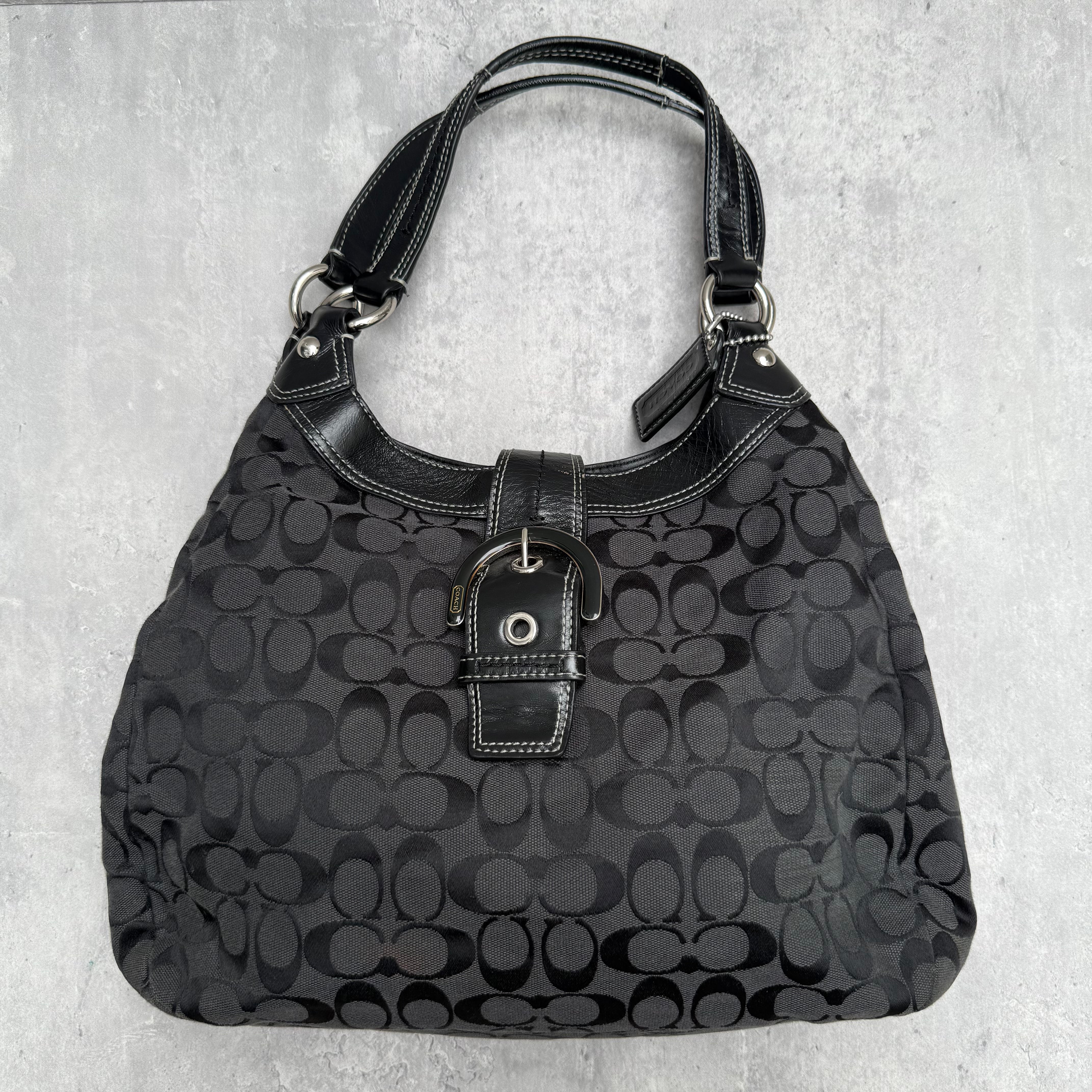 Coach Y2K Soho Hobo Buckle Shoulder Bag in black signature jacquard with leather trim and silver-tone hardware.