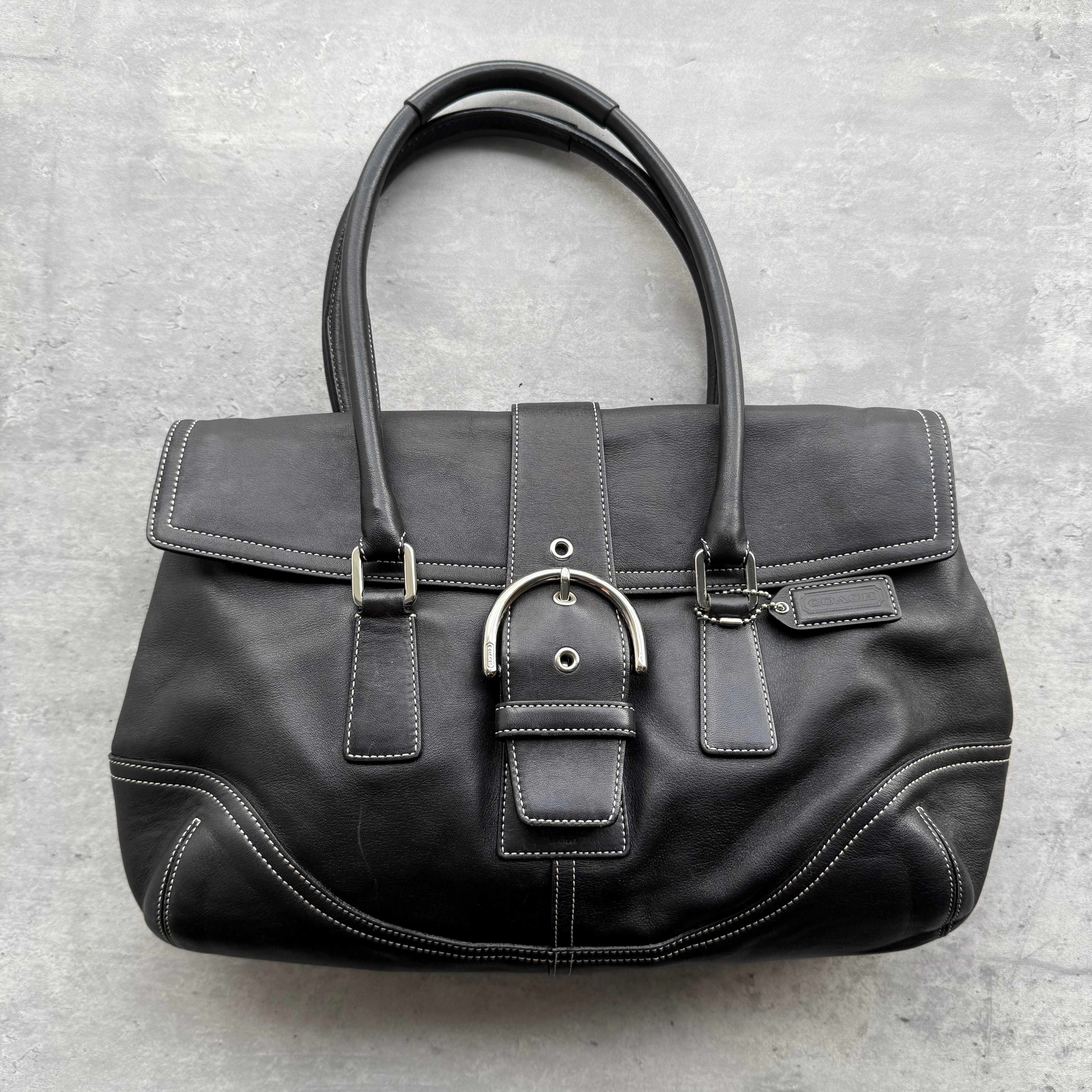 Coach Y2K Soho Shoulder Bag in black leather with contrast stitching, front buckle detail, and dual rolled handles.