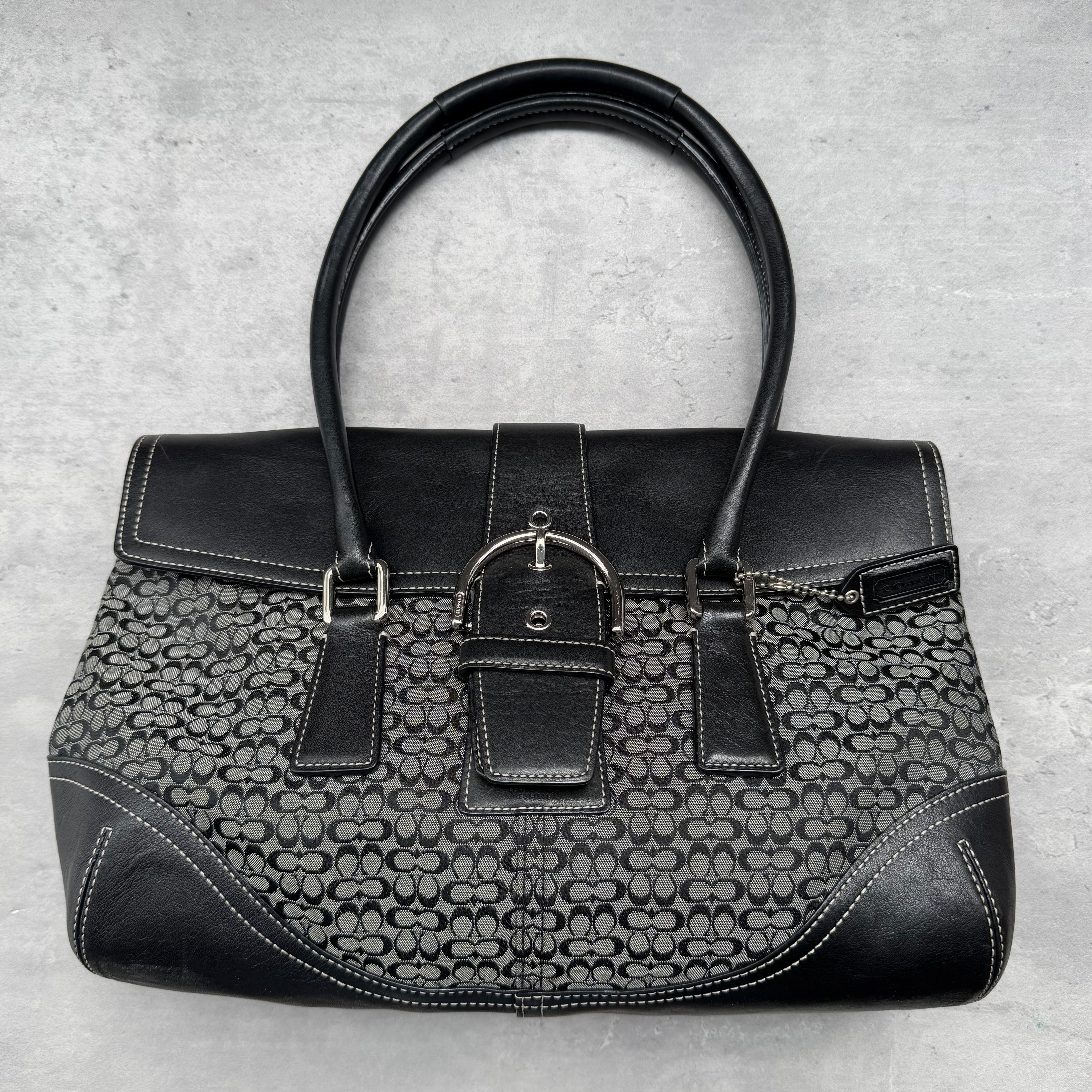 Coach Y2K Soho Shoulder Bag in black and grey jacquard canvas with leather trim, silver-tone buckle detail, and structured silhouette.