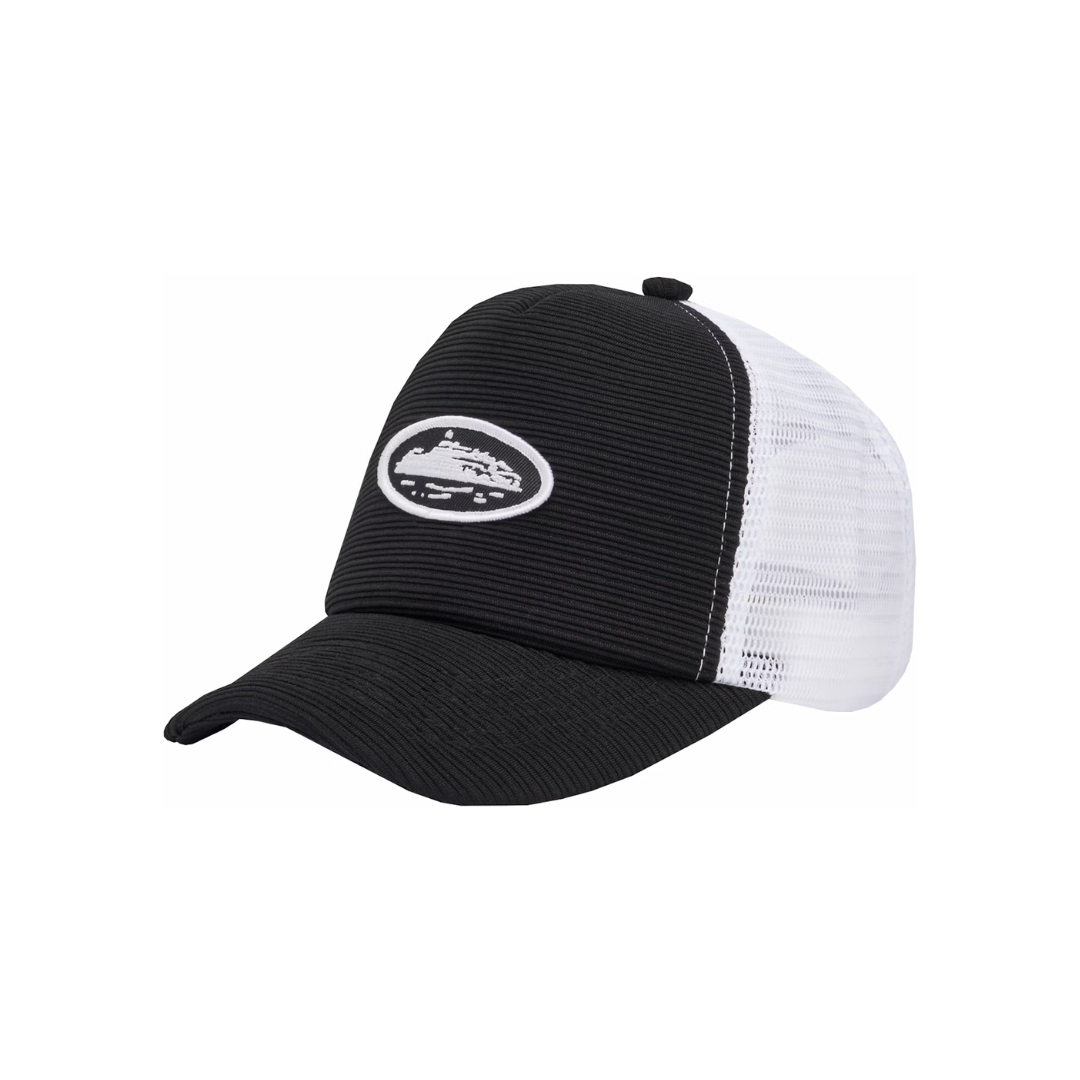 Corteiz Short Peak Trucker Black Cap with embroidered crest logo, black front panel, and white mesh back.