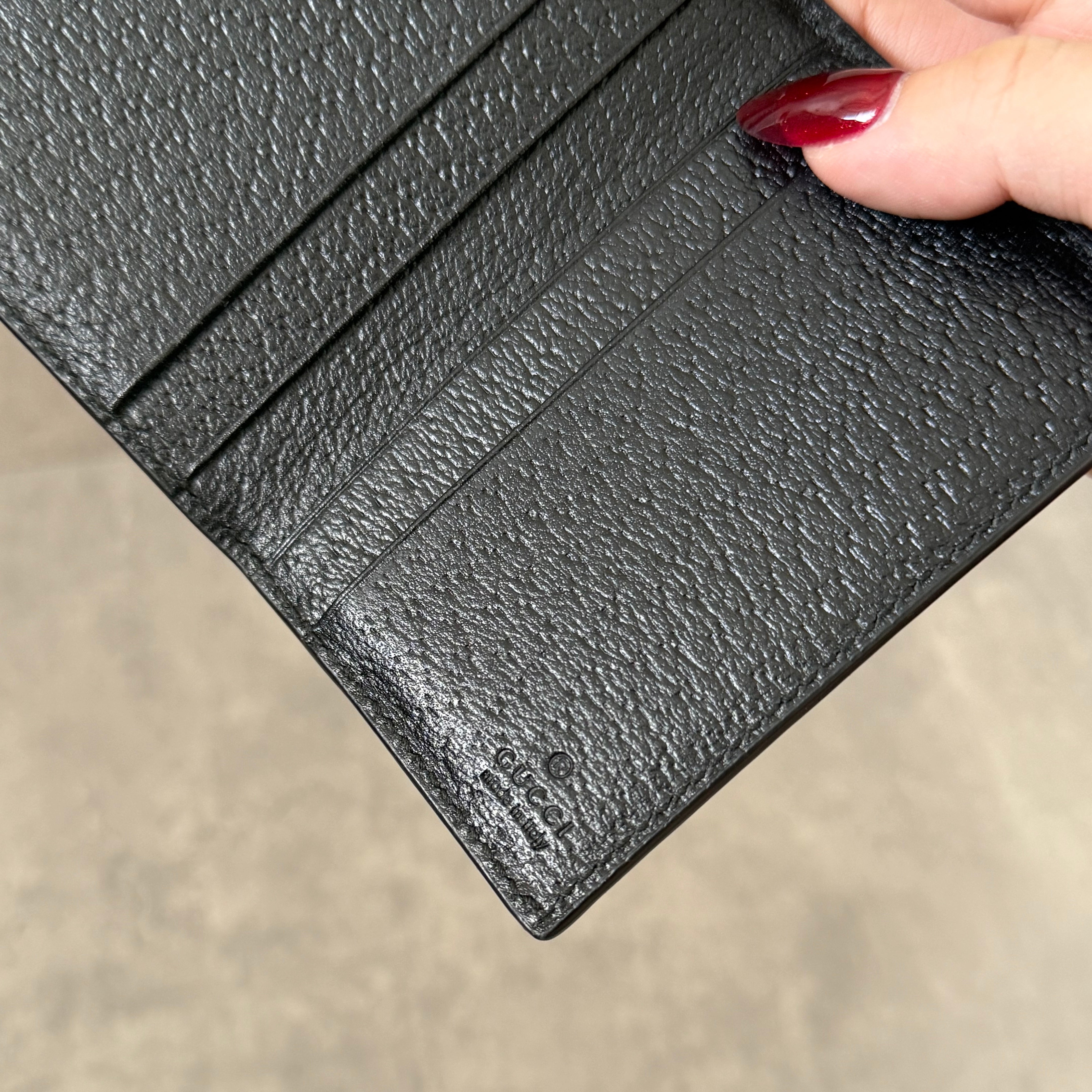 Gucci Interlocking G Black Leather Cardholder, featuring pebbled leather and silver-tone logo hardware in a slim bifold design