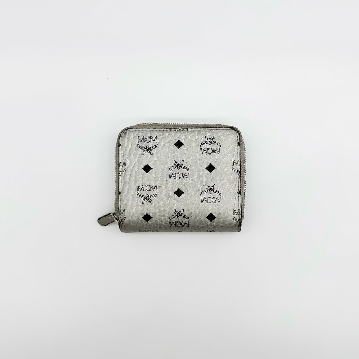 MCM Visetos Monogram wallet in metallic silver with black logo pattern on a clean white background.