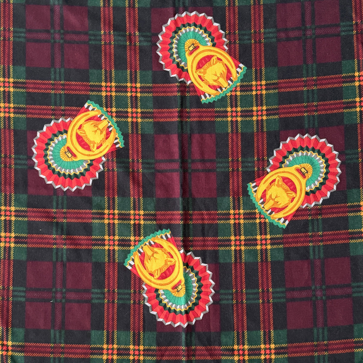Gucci equestrian tartan shawl scarf in burgundy with heritage motifs and a fringed edge, styled folded.