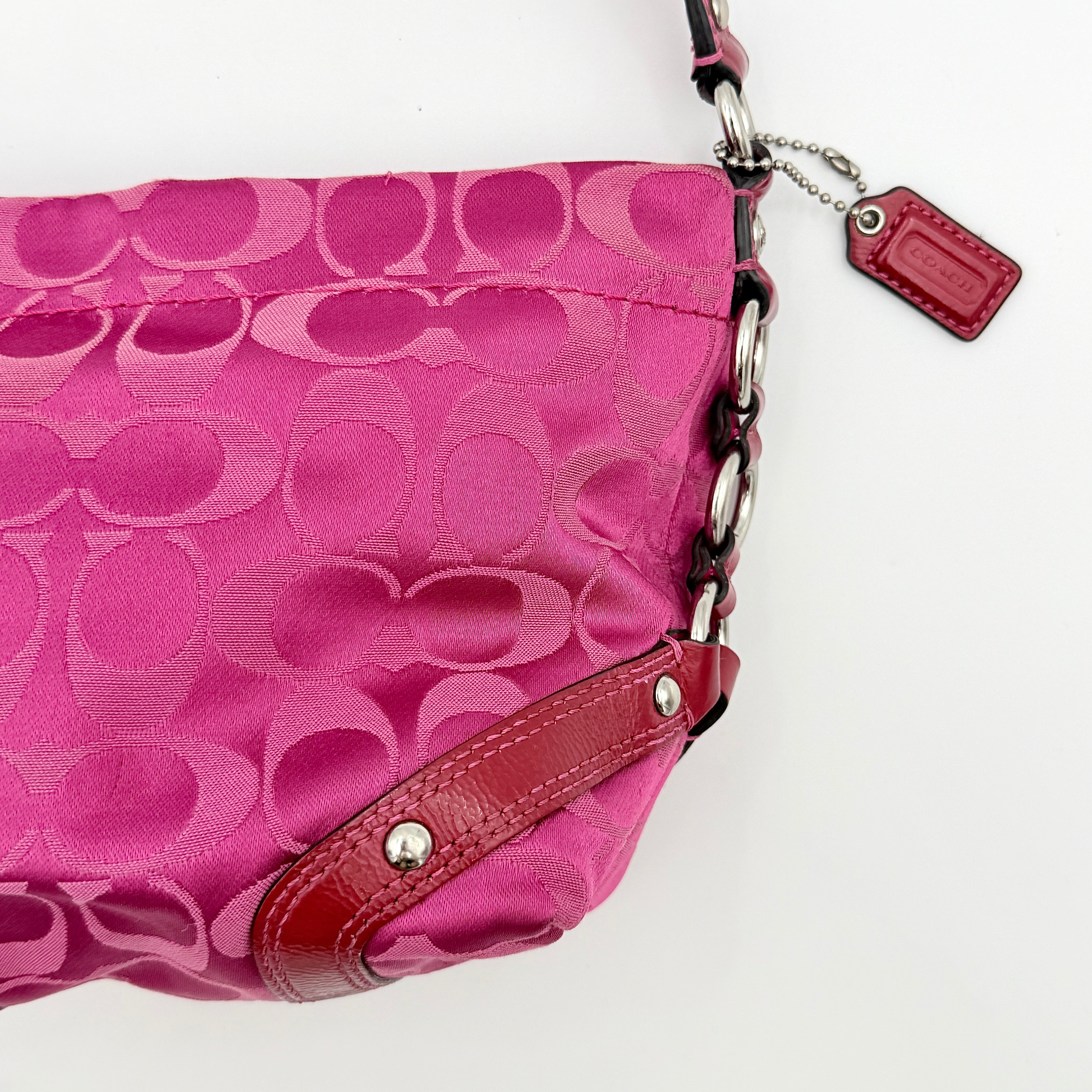 Coach Carly Hobo Shoulder Bag in vivid pink jacquard and leather, featuring signature chain detail and silver hardware.