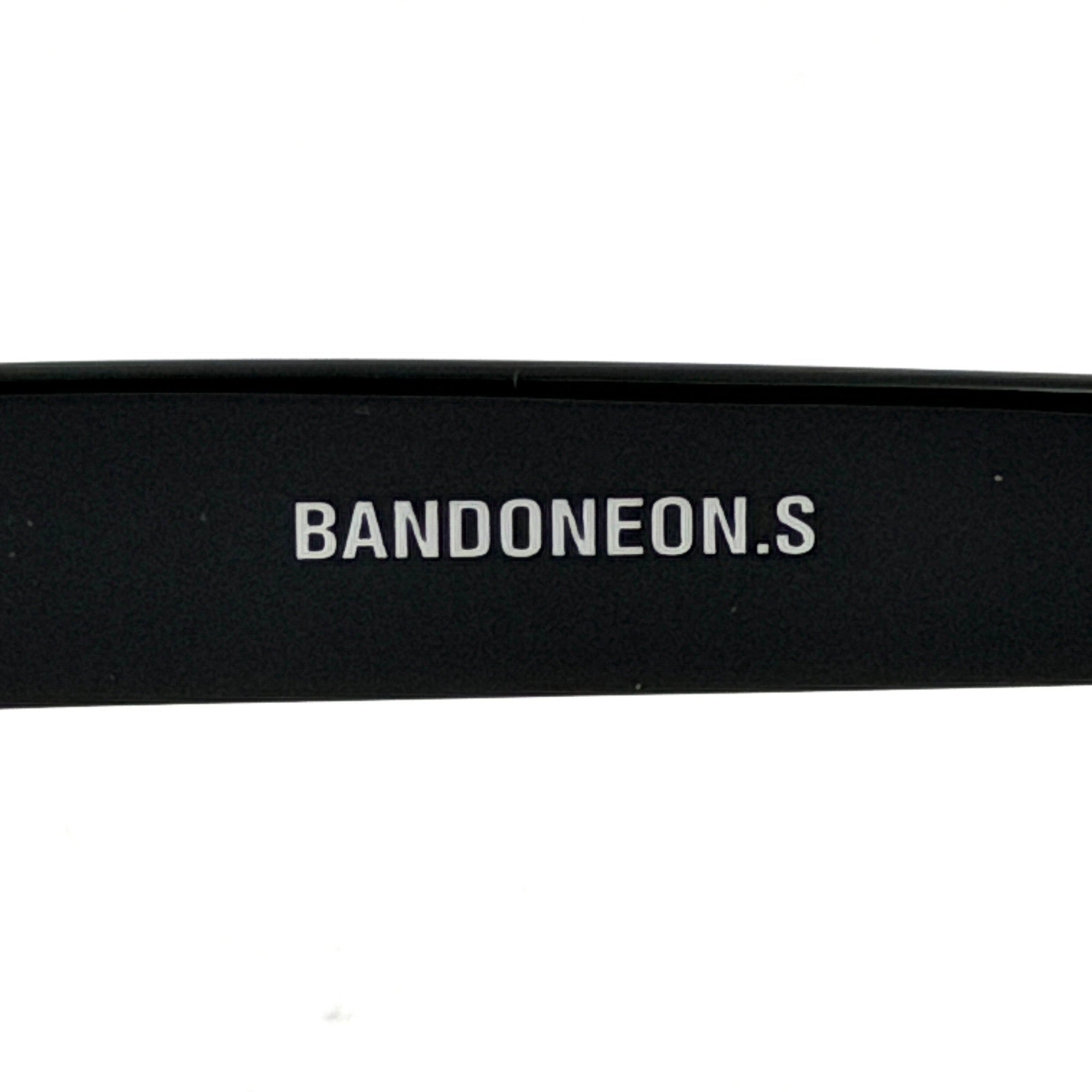 Gentle Monster Bandoneon.S sunglasses in black acetate with dark oval lenses and silver star accents shown from the side.