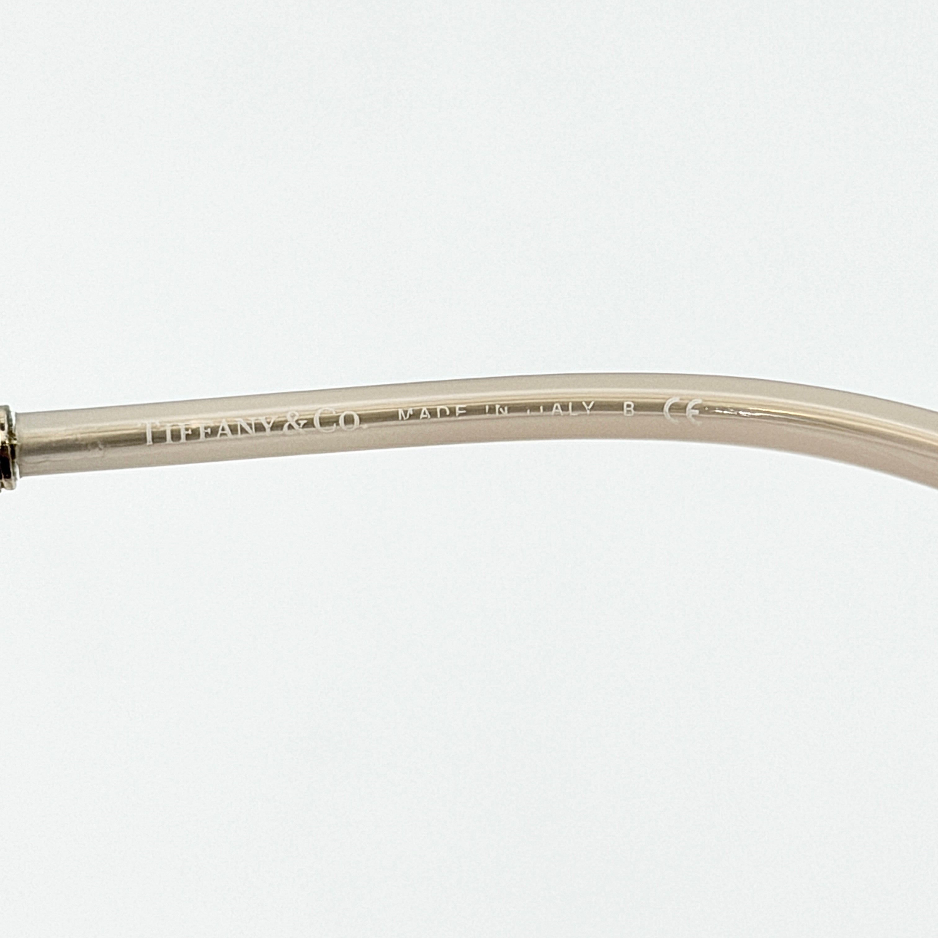 Tiffany & Co. TF4144 sunglasses in pink with gold-tone knot detail arms, shown with signature blue case.