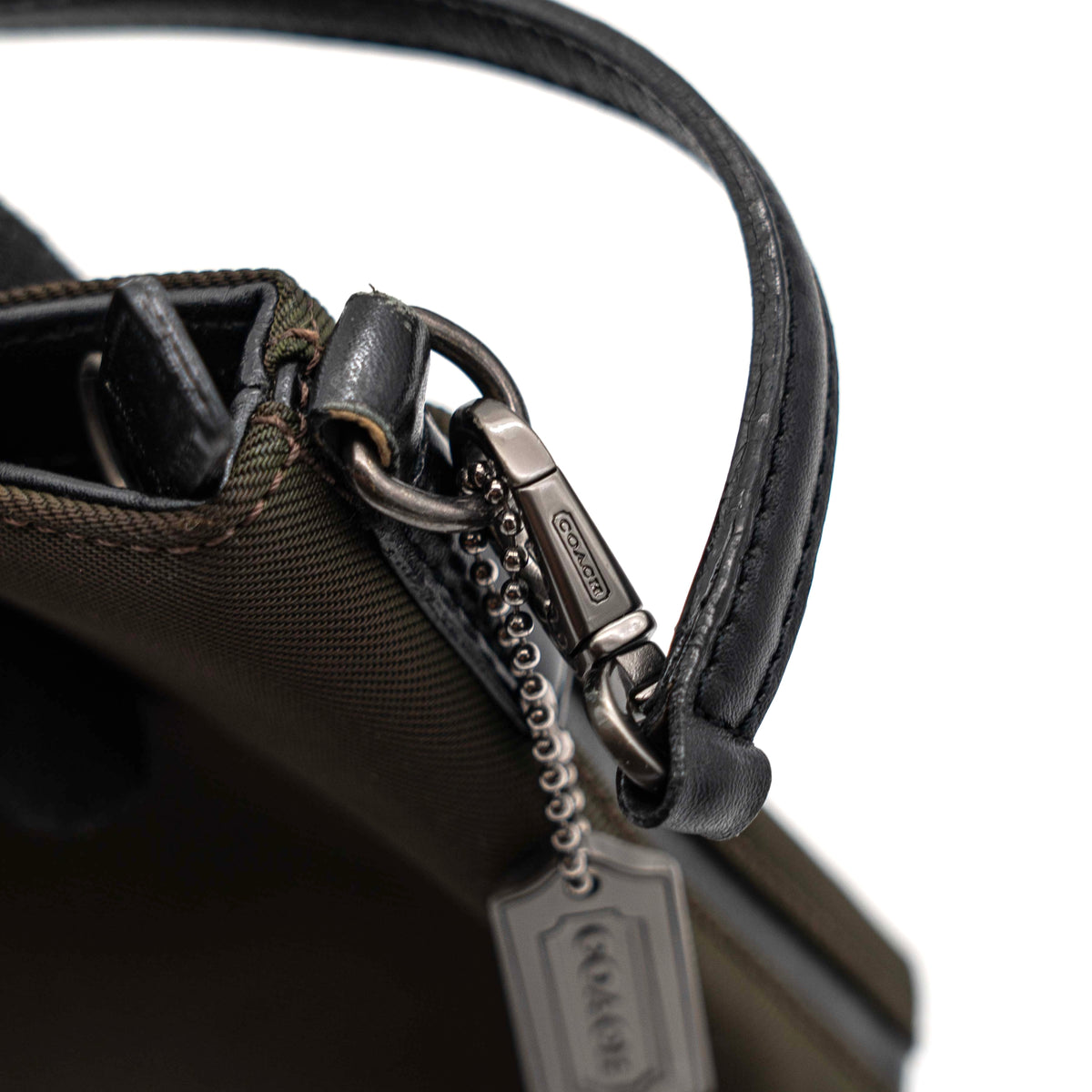 Coach Mercer Demi Tote Bag in brown nylon with black leather trim and gunmetal hardware, shown with signature Coach tag.