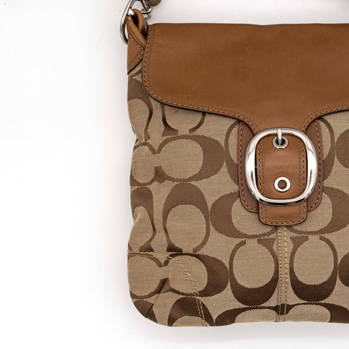 Coach 2Way Signature Soho Buckle Flap Shoulder Bag in beige and tan with silver buckle and adjustable leather strap, shown on a white background.