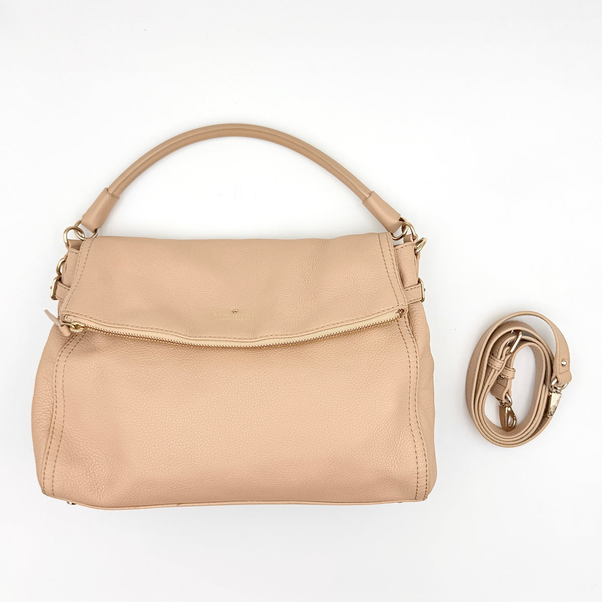 Kate Spade Cobble Hill Little Minka in beige pebbled leather with both top handle and detachable strap displayed.