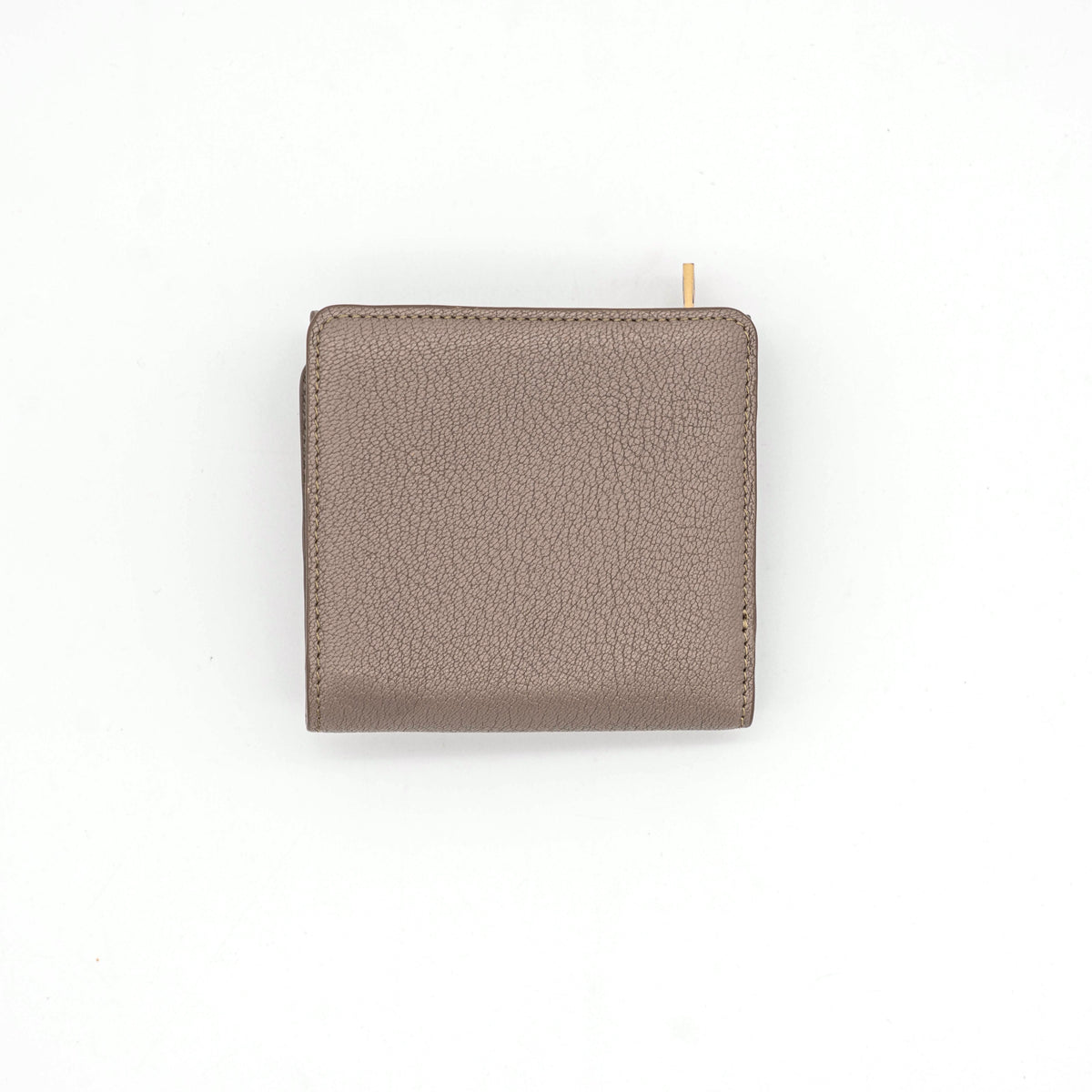 See by Chloe Hana tri-fold wallet in grey grained leather with gold-tone ring and charms, photographed closed on a white background.