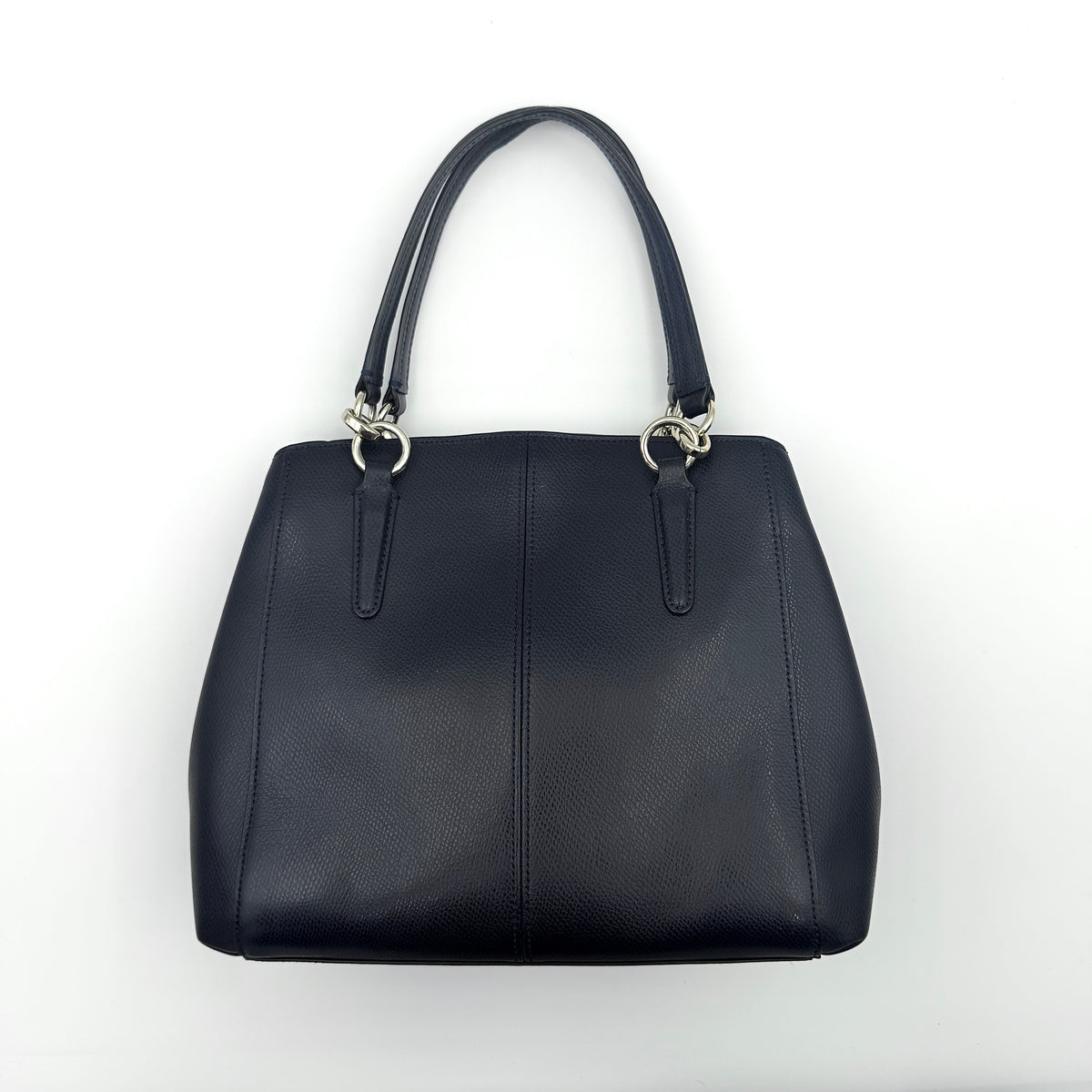 Coach Minetta Satchel in navy blue grained leather with dual handles and detachable shoulder strap displayed on a white background.