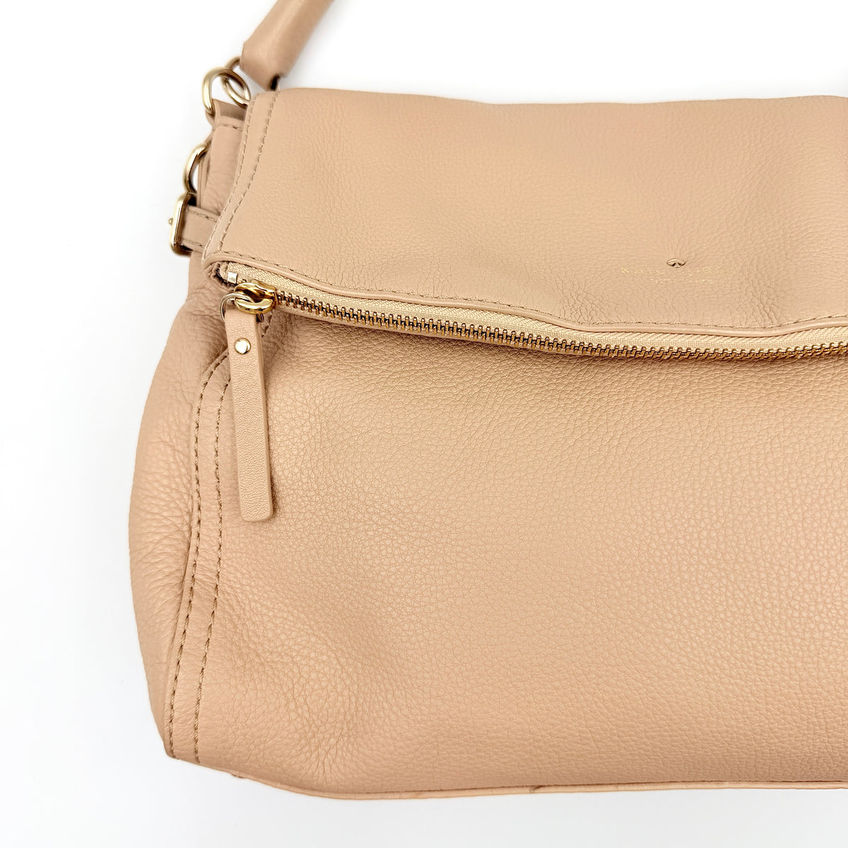 Kate Spade Cobble Hill Little Minka in beige pebbled leather with both top handle and detachable strap displayed.