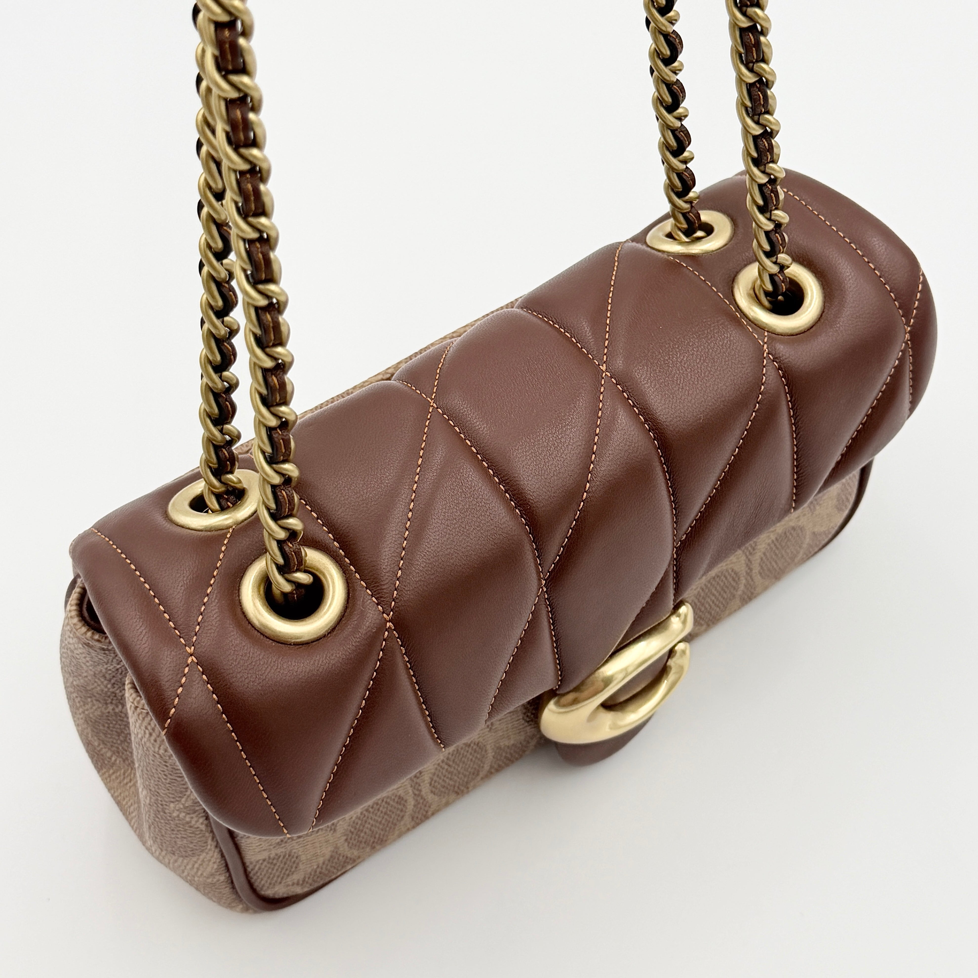 Coach Signature Quilted Tabby Shoulder Bag in brown monogram canvas with gold chain strap and oversized C clasp.