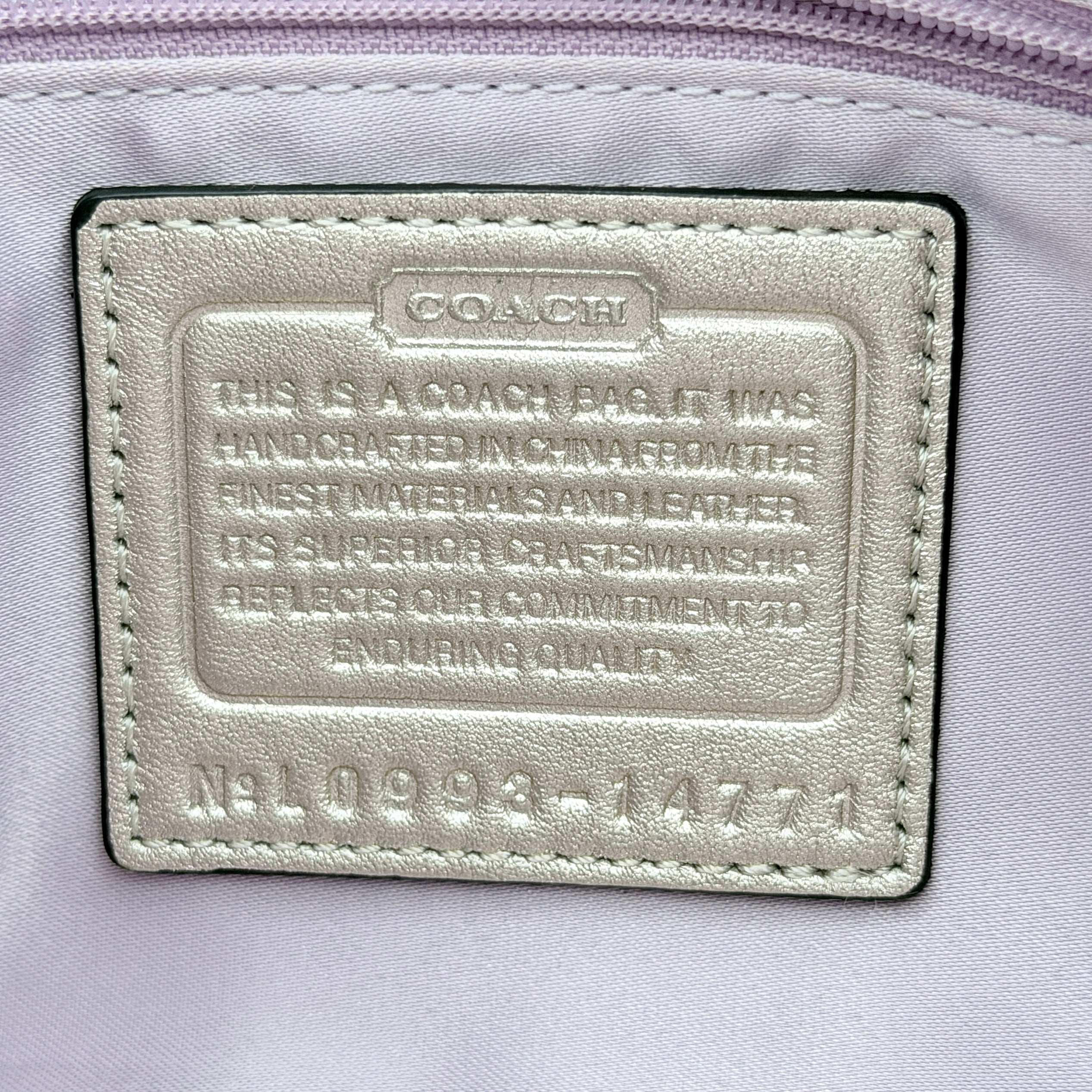 Coach Kristin Hobo Shoulder Bag in ivory leather with silver-tone hardware and a structured short strap.