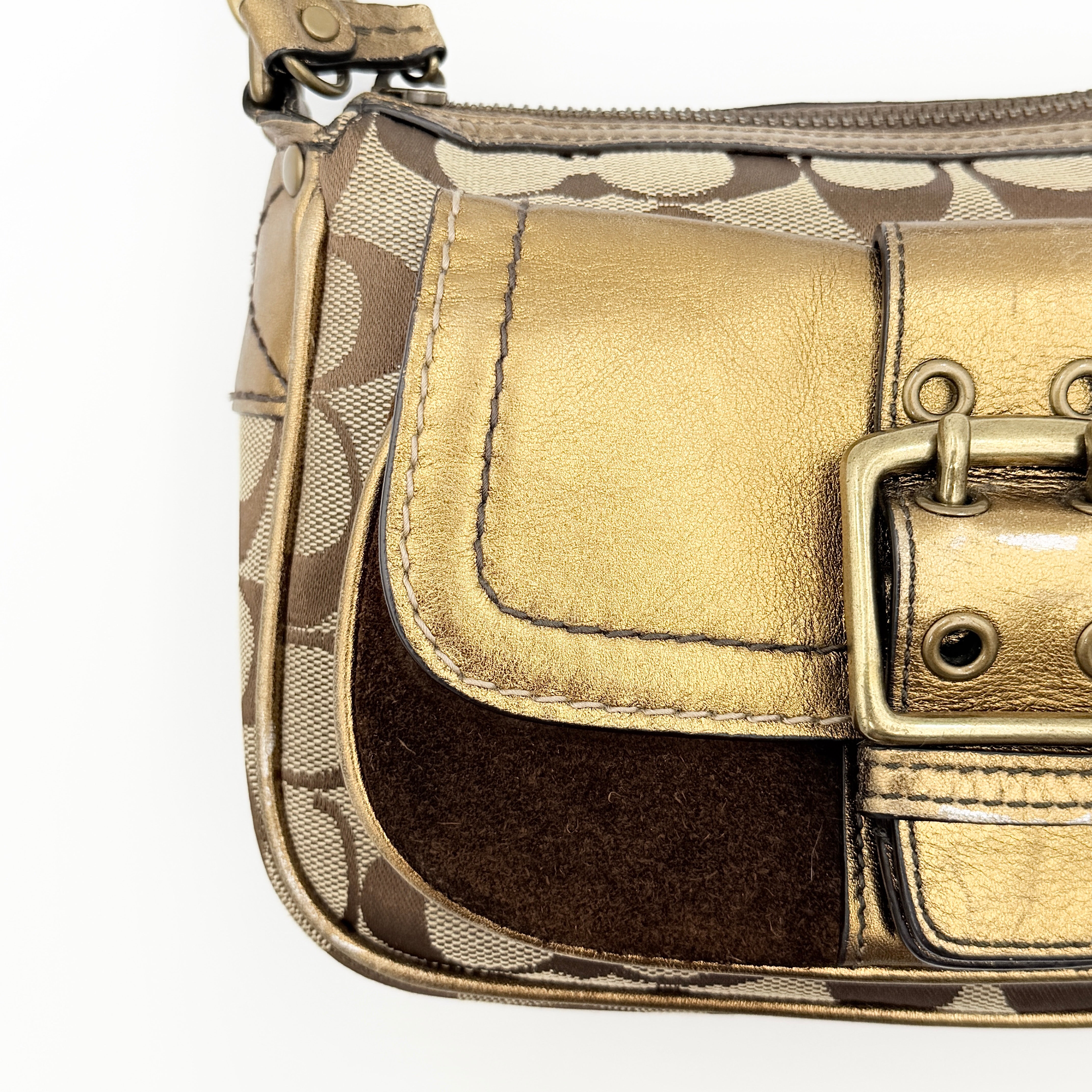 Coach Signature shoulder bag in beige jacquard with gold leather front flap, showcased on a plain background.
