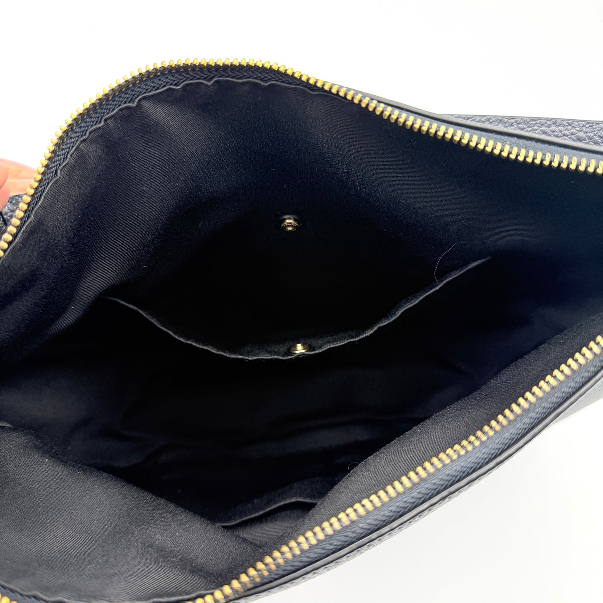 Coach Elle Hobo bag in navy blue pebbled leather with gold hardware and a detachable strap, styled on a white background.