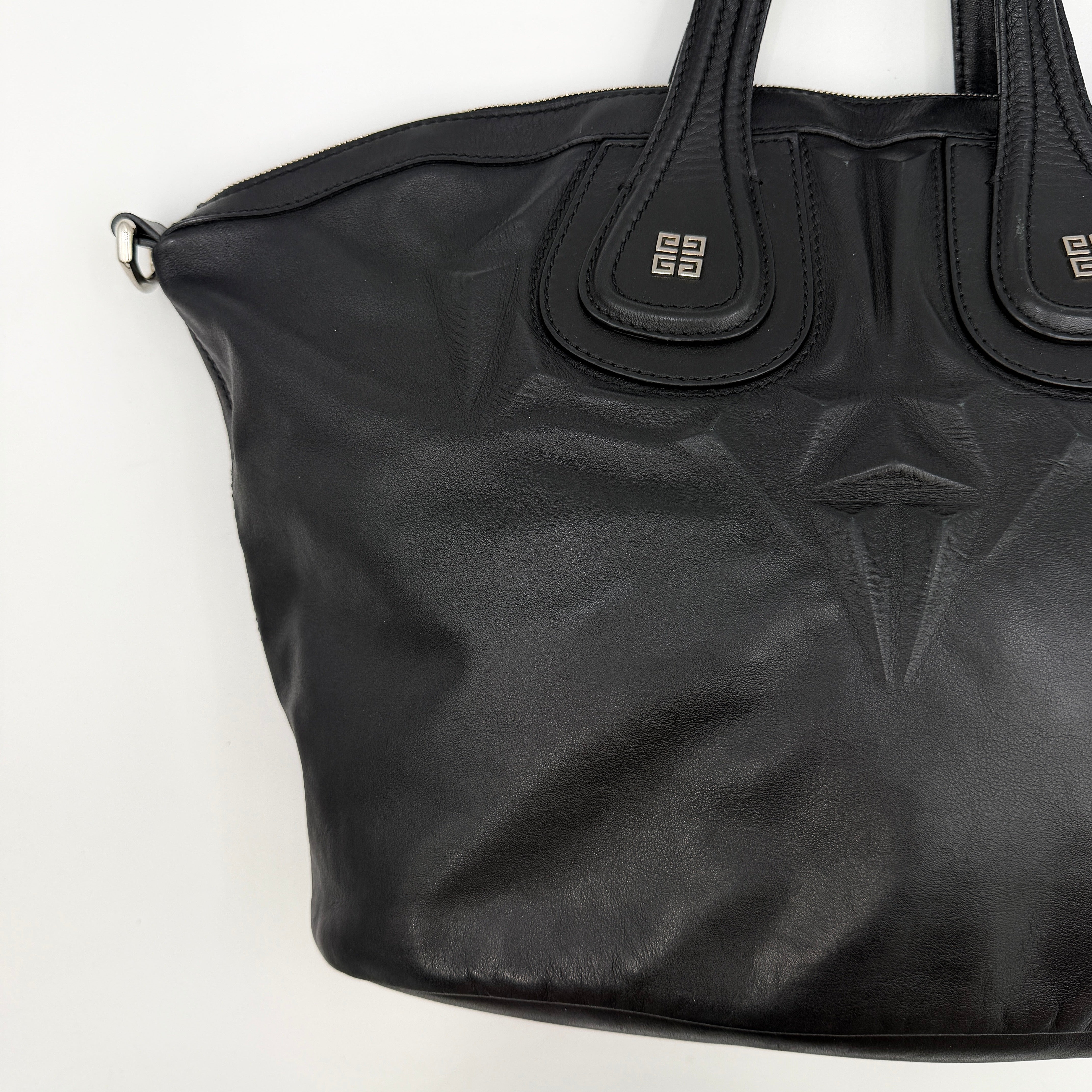 Givenchy 2Way Nightingale Handbag in black leather with detachable strap and striking front motif.
