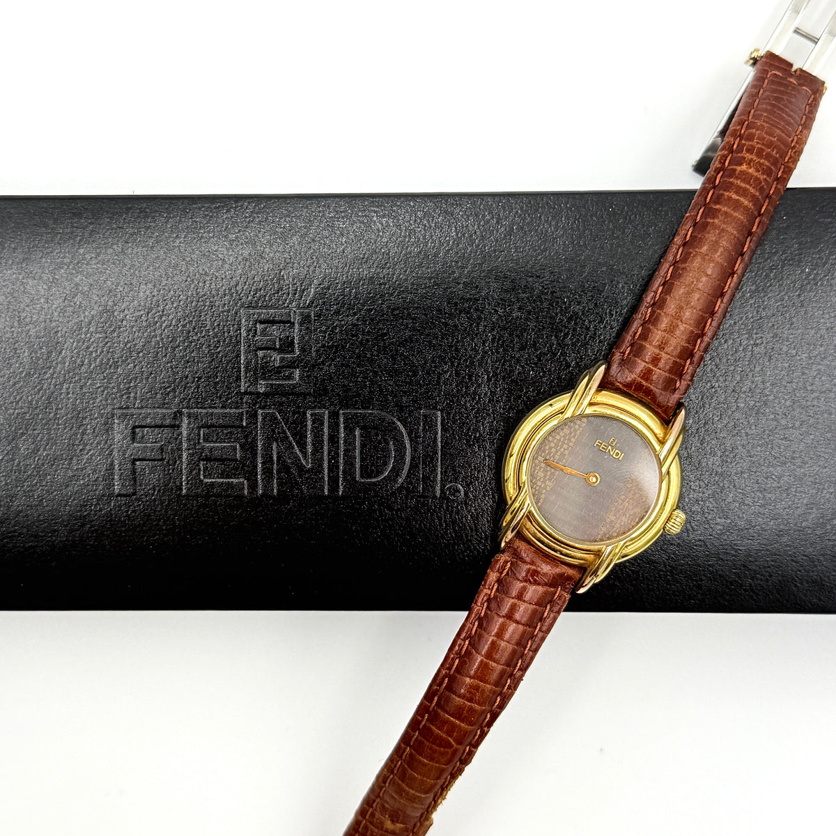 Fendi 350L Orologi Quartz Watch in gold with brown leather strap, displayed with original box and booklet.