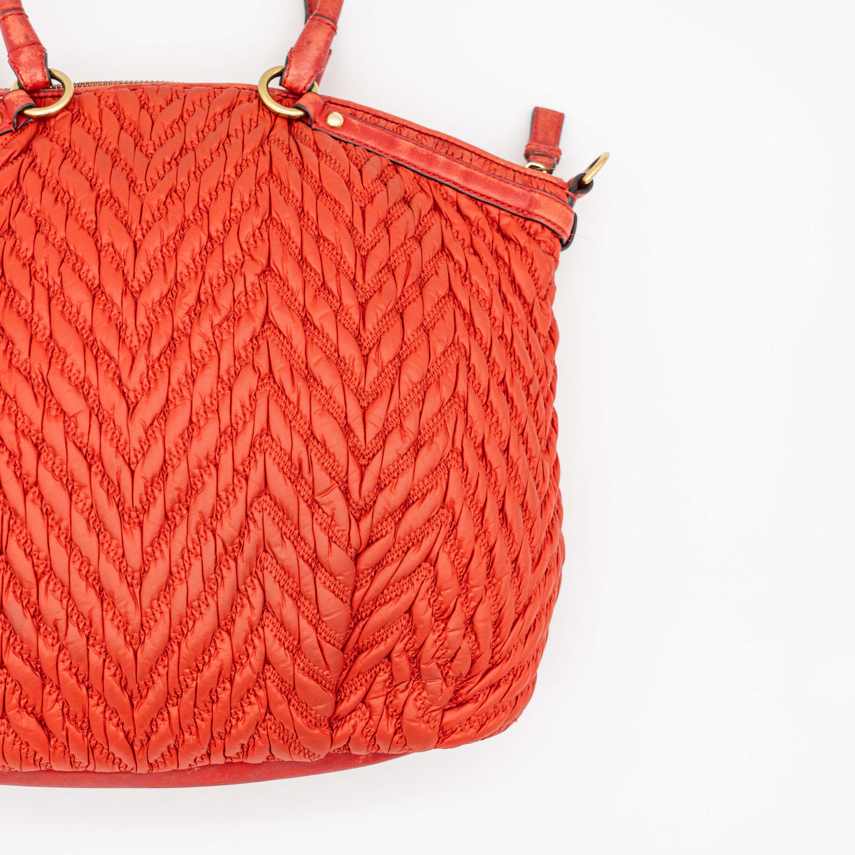 Coach Madison 2Way shoulder bag in rich red quilted texture with gold hardware, top handles, and detachable strap, displayed on a white background.