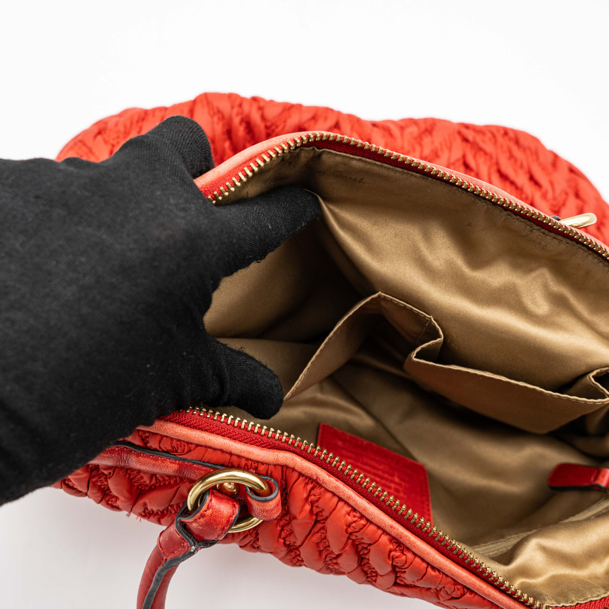 Coach Madison 2Way shoulder bag in rich red quilted texture with gold hardware, top handles, and detachable strap, displayed on a white background.