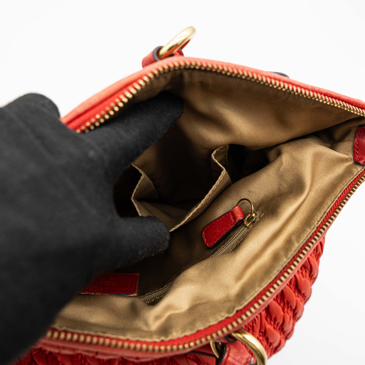 Coach Madison 2Way shoulder bag in rich red quilted texture with gold hardware, top handles, and detachable strap, displayed on a white background.