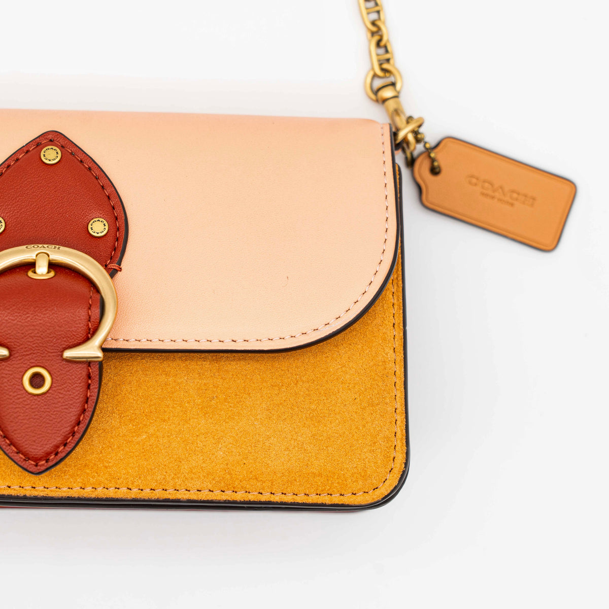 Coach Beat Crossbody Clutch 2Way in blush, tan, and red leather with brass hardware and detachable strap, displayed with chain handle.