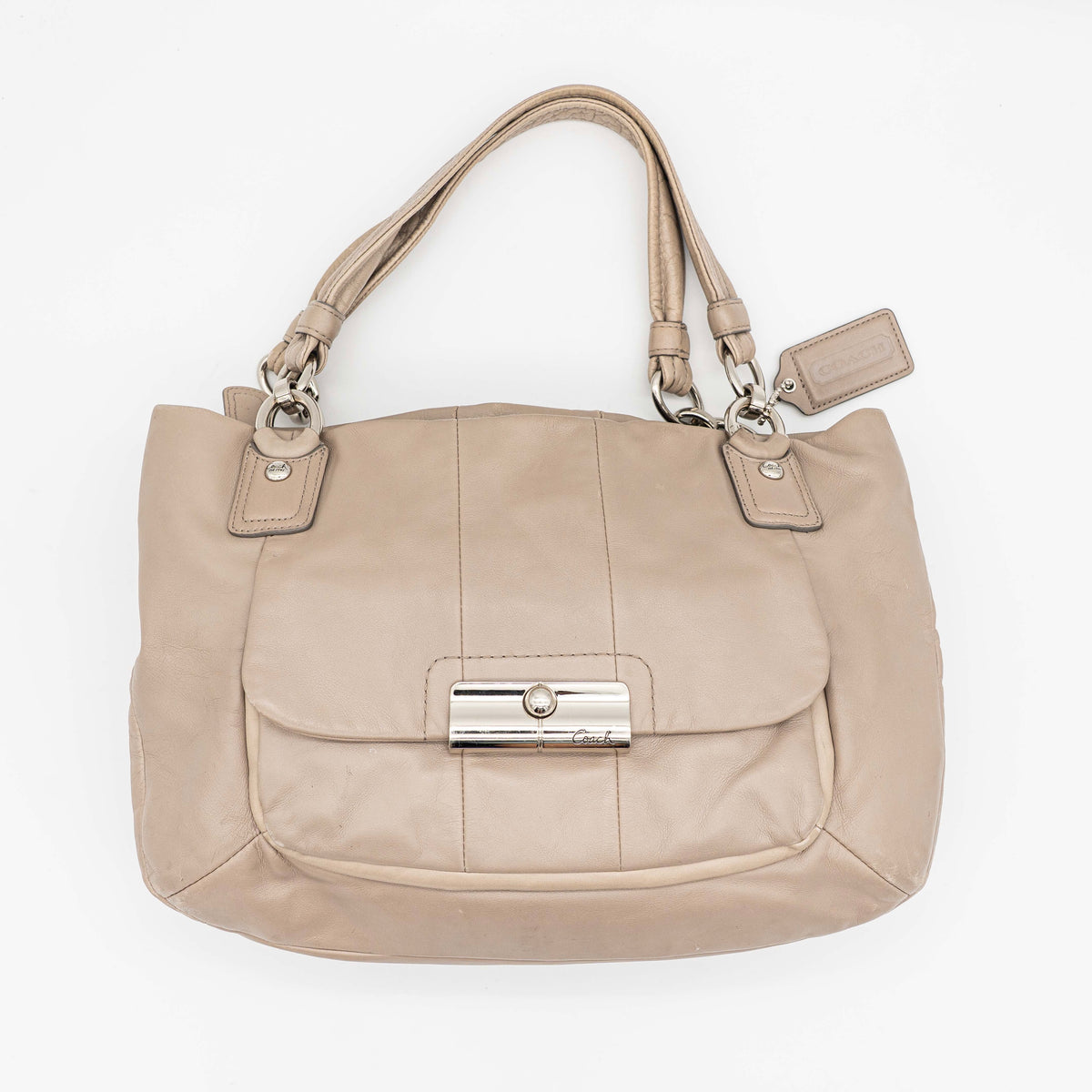 Coach Kristin East West Shoulder Bag in beige leather with silver-tone hardware and double handles.