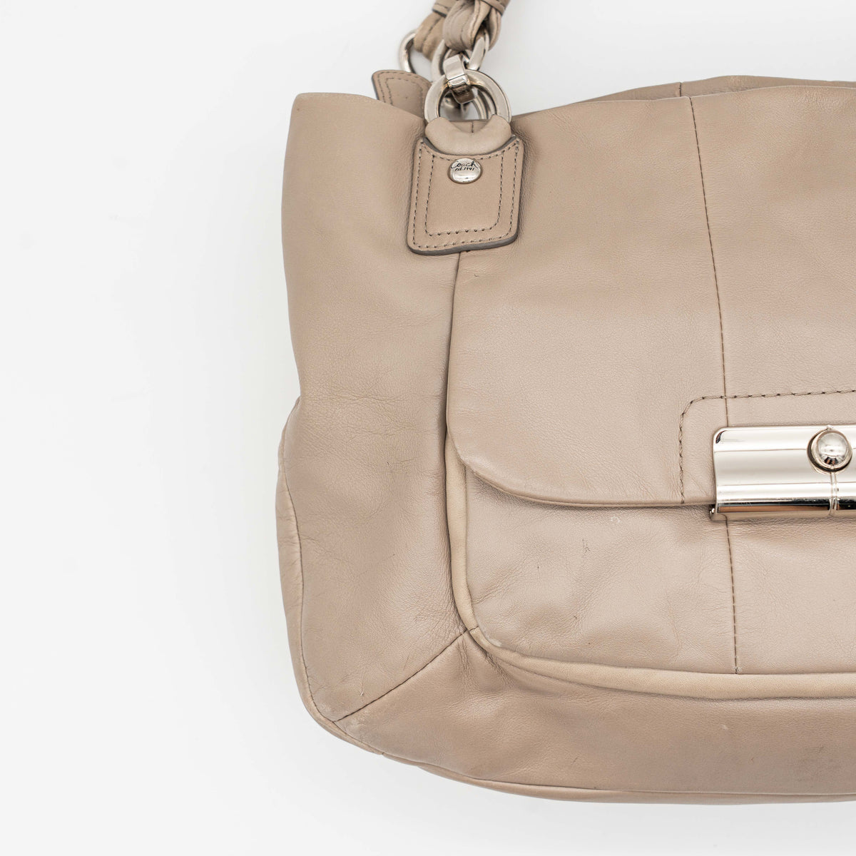 Coach Kristin East West Shoulder Bag in beige leather with silver-tone hardware and double handles.