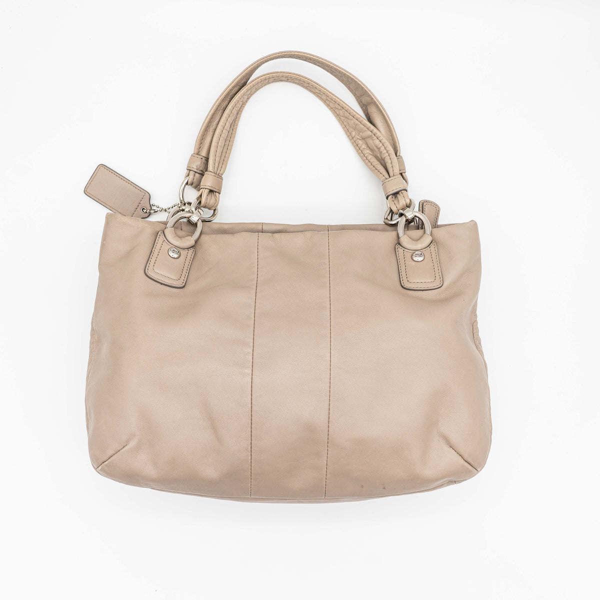 Coach Kristin East West Shoulder Bag in beige leather with silver-tone hardware and double handles.