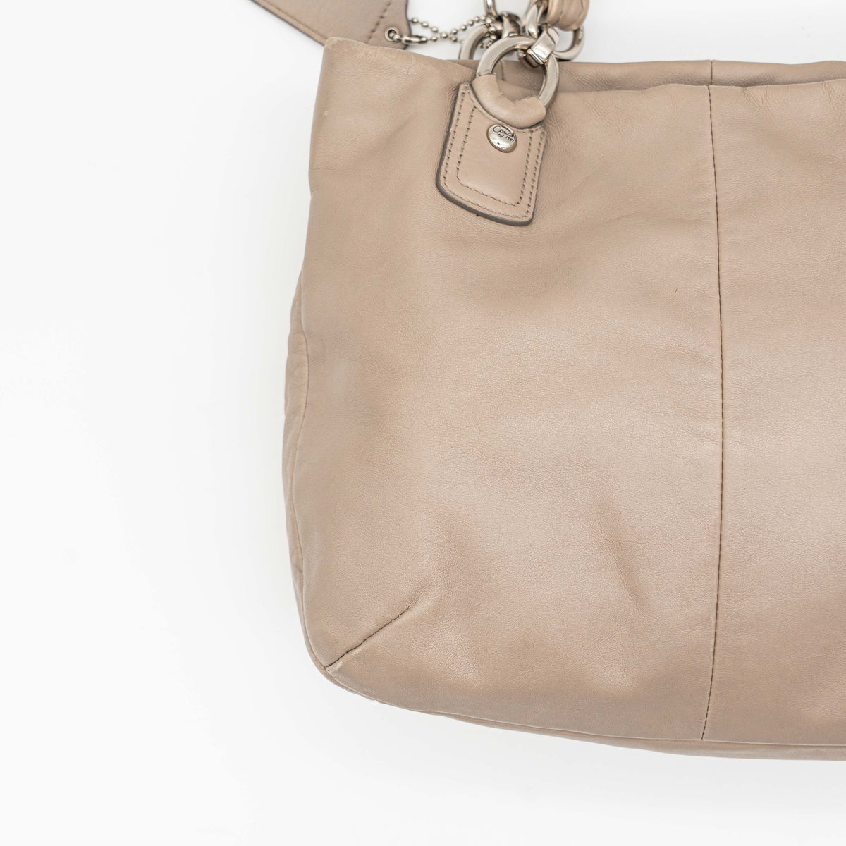 Coach Kristin East West Shoulder Bag in beige leather with silver-tone hardware and double handles.