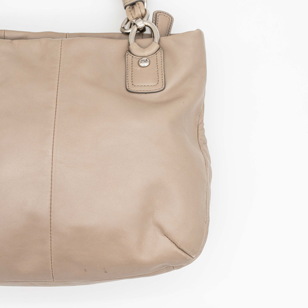Coach Kristin East West Shoulder Bag in beige leather with silver-tone hardware and double handles.