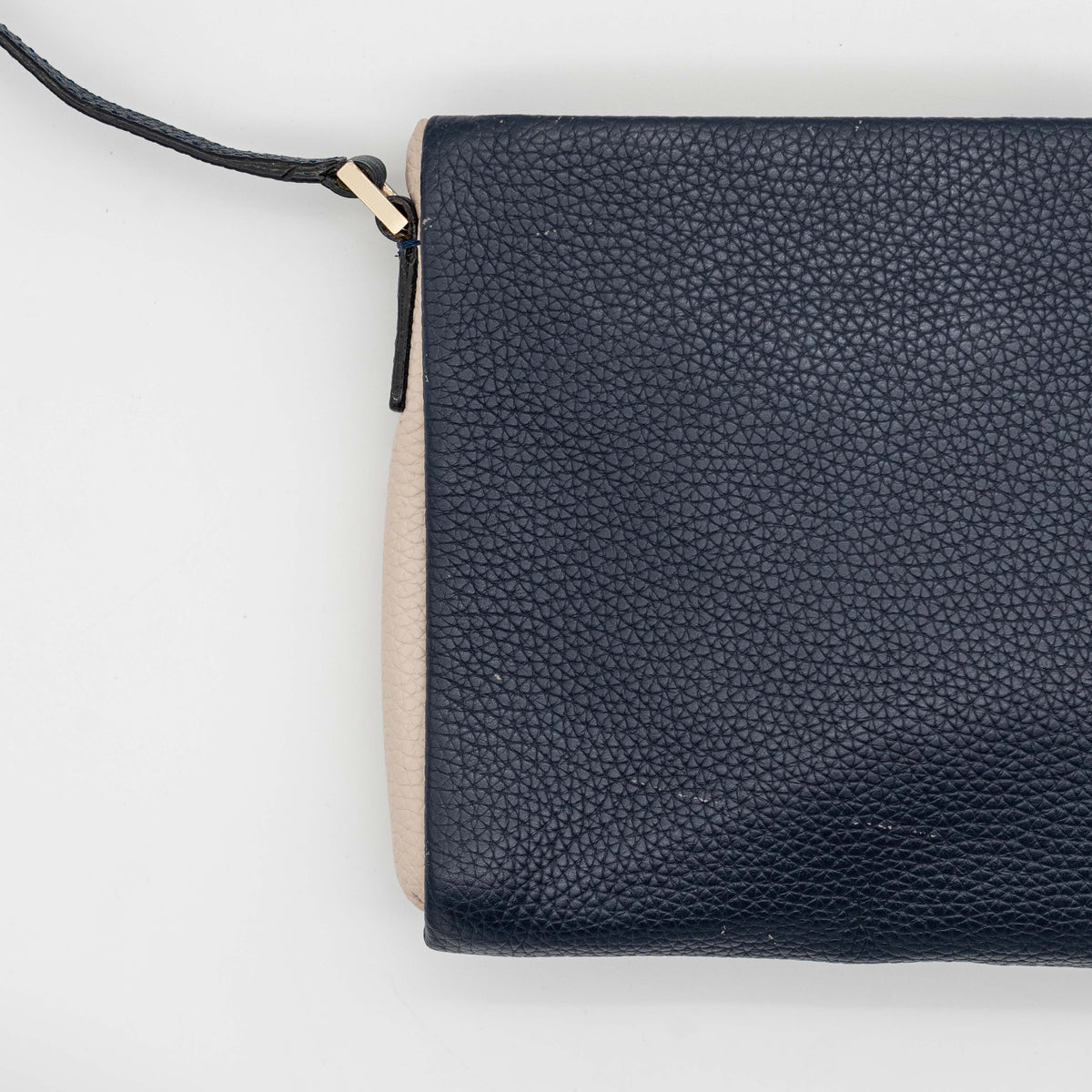 Kate Spade navy blue crossbody bag in pebbled leather, shown with adjustable strap and gold-tone accents.