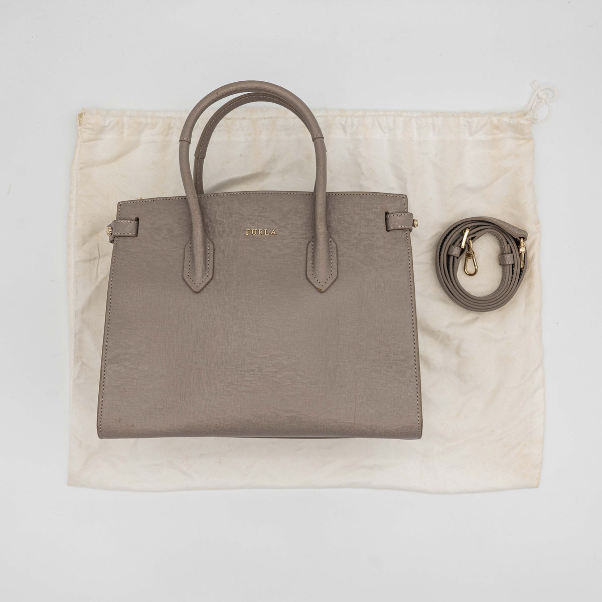 Furla grey Pin tote bag with top handles, gold hardware, and detachable strap against a white background.