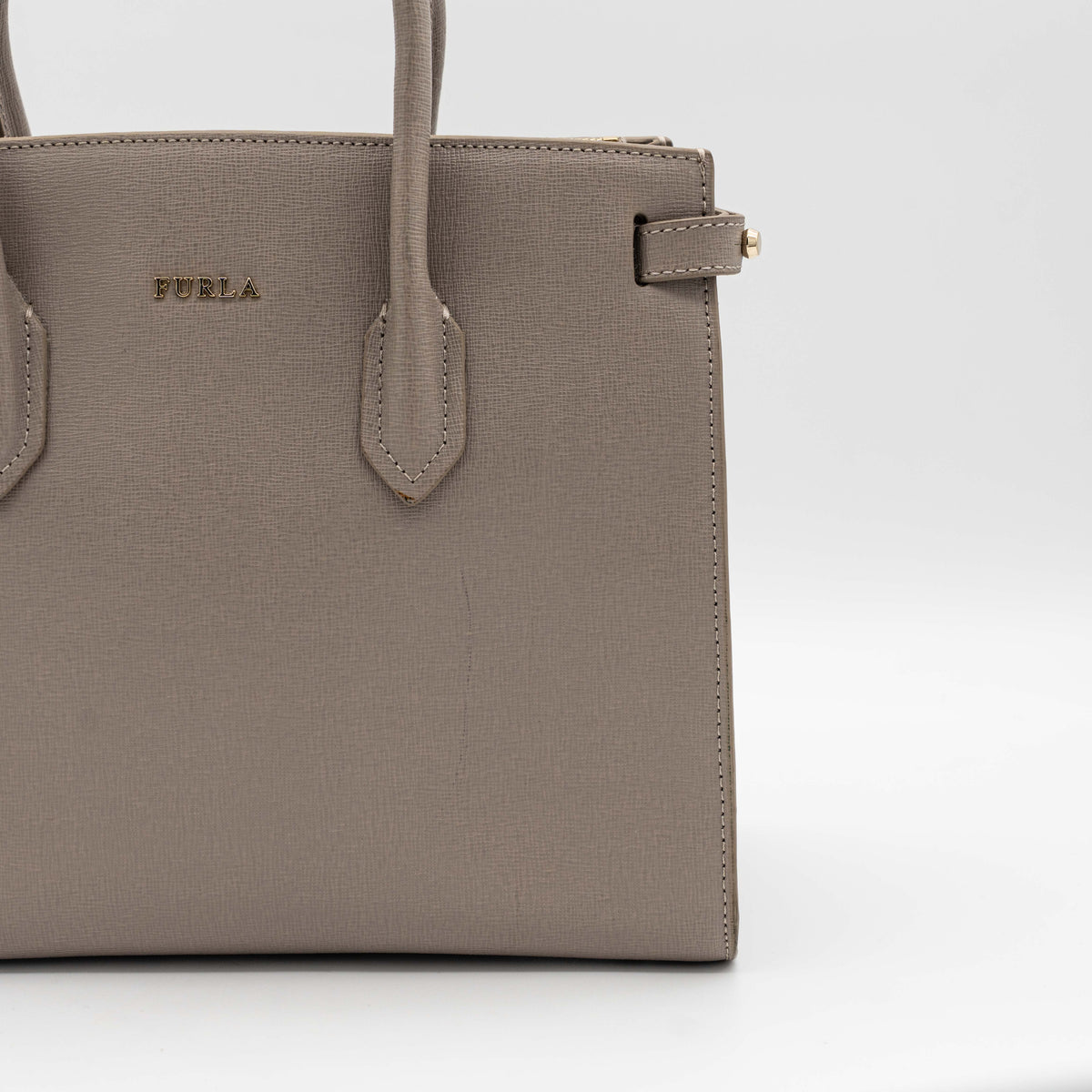 Furla grey Pin tote bag with top handles, gold hardware, and detachable strap against a white background.