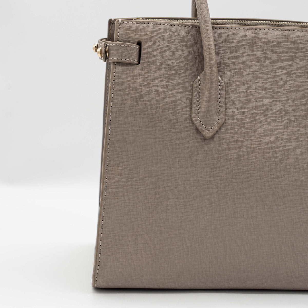 Furla grey Pin tote bag with top handles, gold hardware, and detachable strap against a white background.