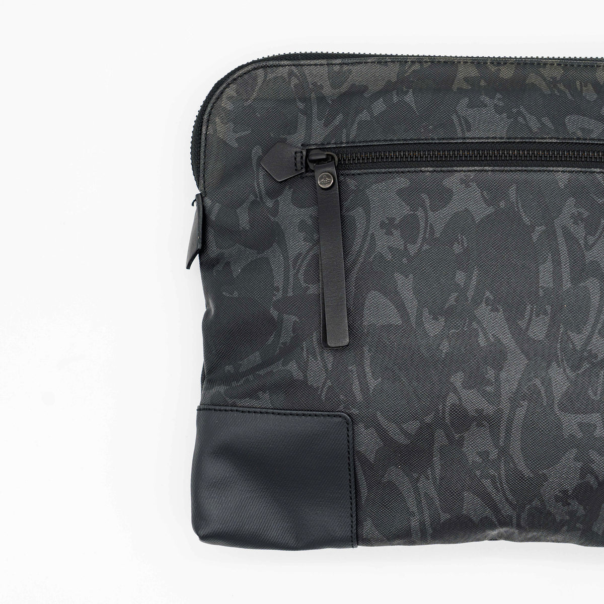 Vivienne Westwood clutch bag in grey and black graphic camouflage with matte black Orb logo and leather trim, styled against a white background.